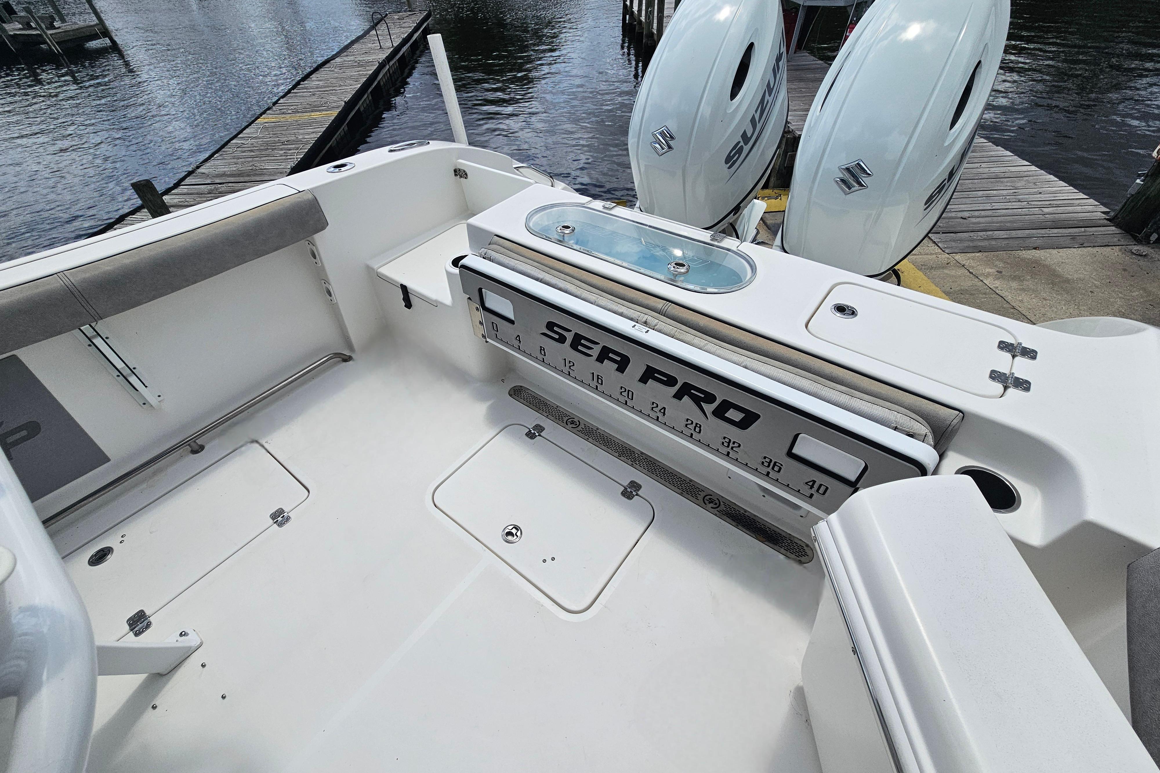 2021 Sea Pro 259 Center Console boat interior with dual Suzuki engines at dock.