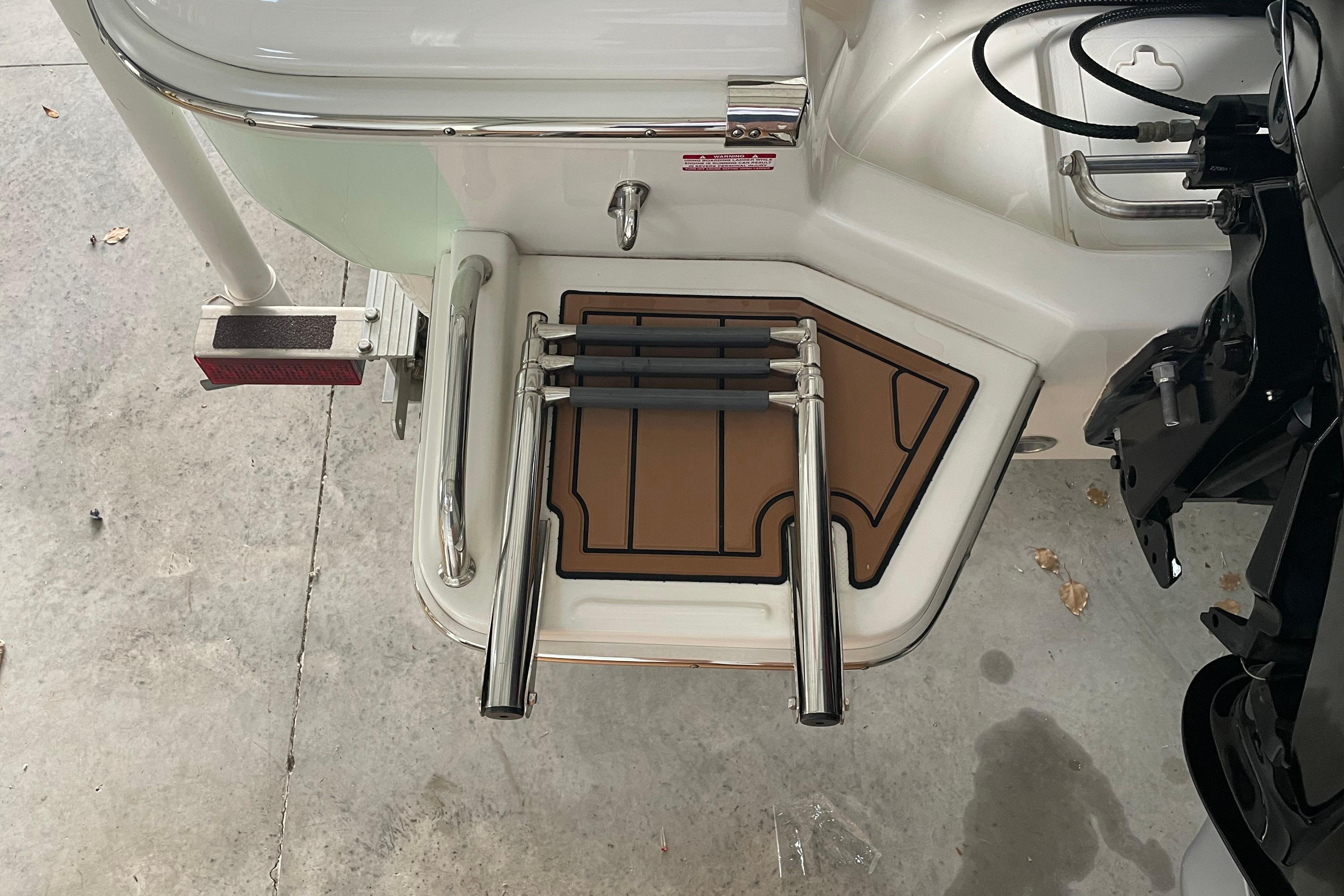 2024 Pioneer 180 Islander boat swim platform with foldable ladder and non-slip mat.