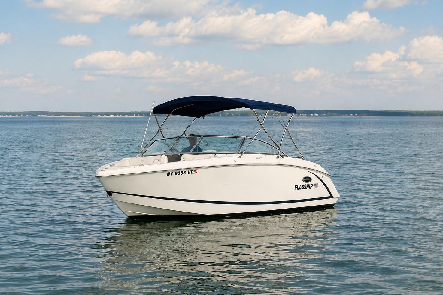 2019 Cobalt R3 boat with canopy on calm water under blue sky.