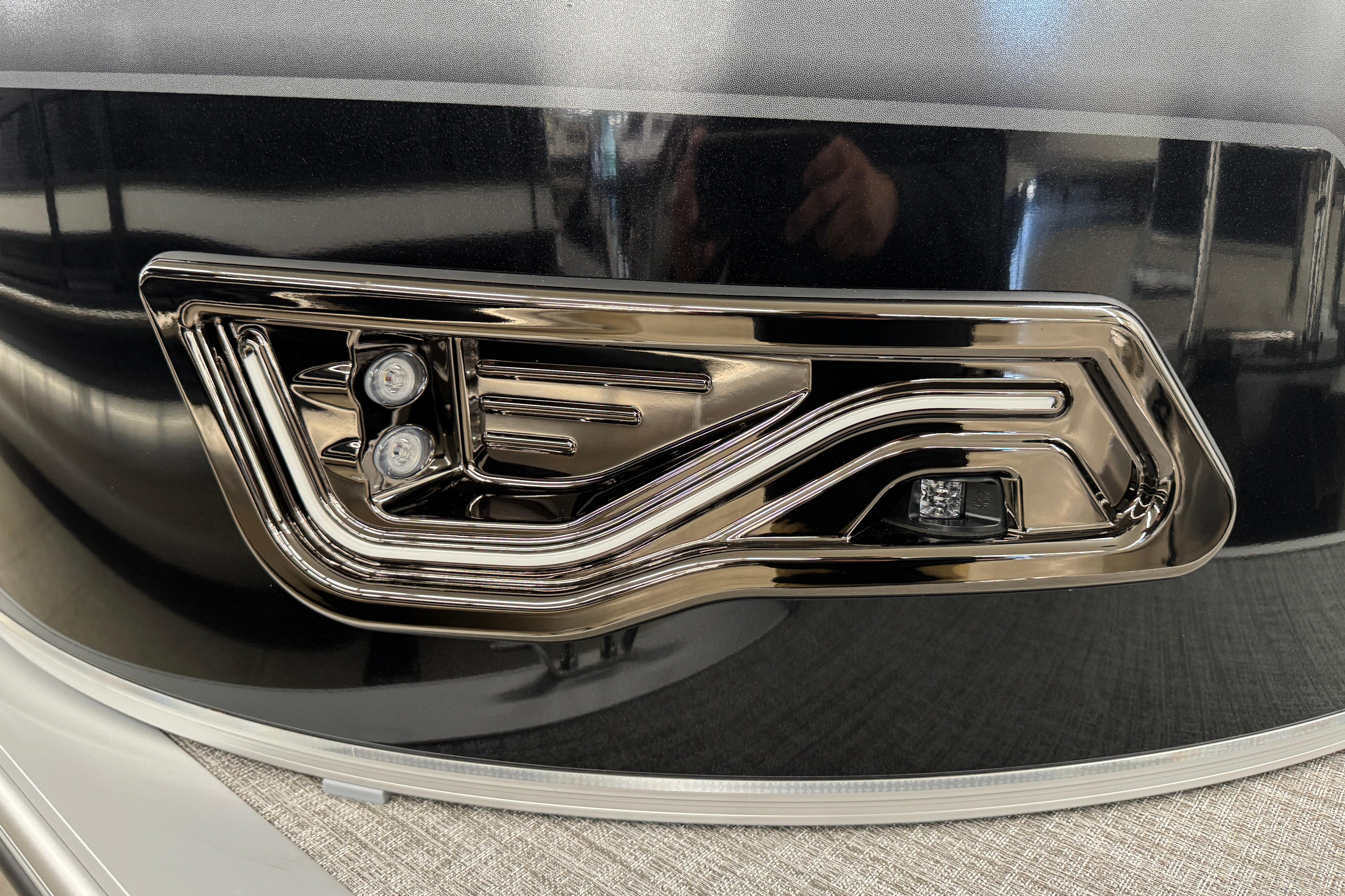 Close-up of 2026 Avalon Ventue 85 RF boat's sleek chrome detailing and LED lights.