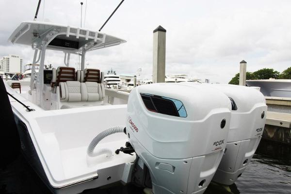 2024 Jupiter 34 HFS boat with dual outboard engines docked at marina.