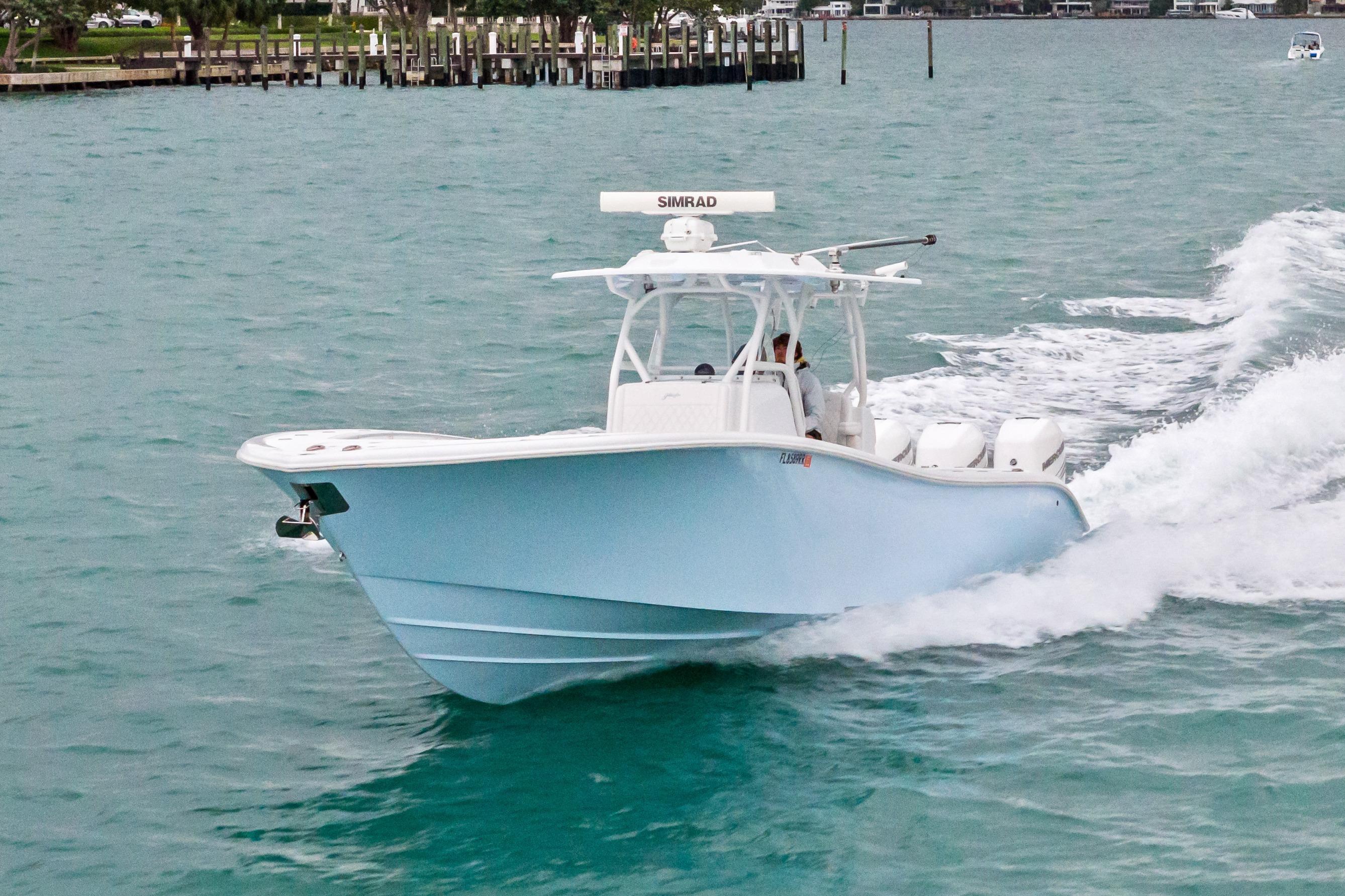 2021 Yellowfin 36 Offshore boat cruising on turquoise water.