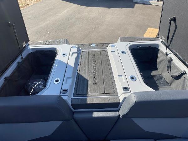 2025 Moomba Mondo boat storage compartments with open hatches on a sunny day.
