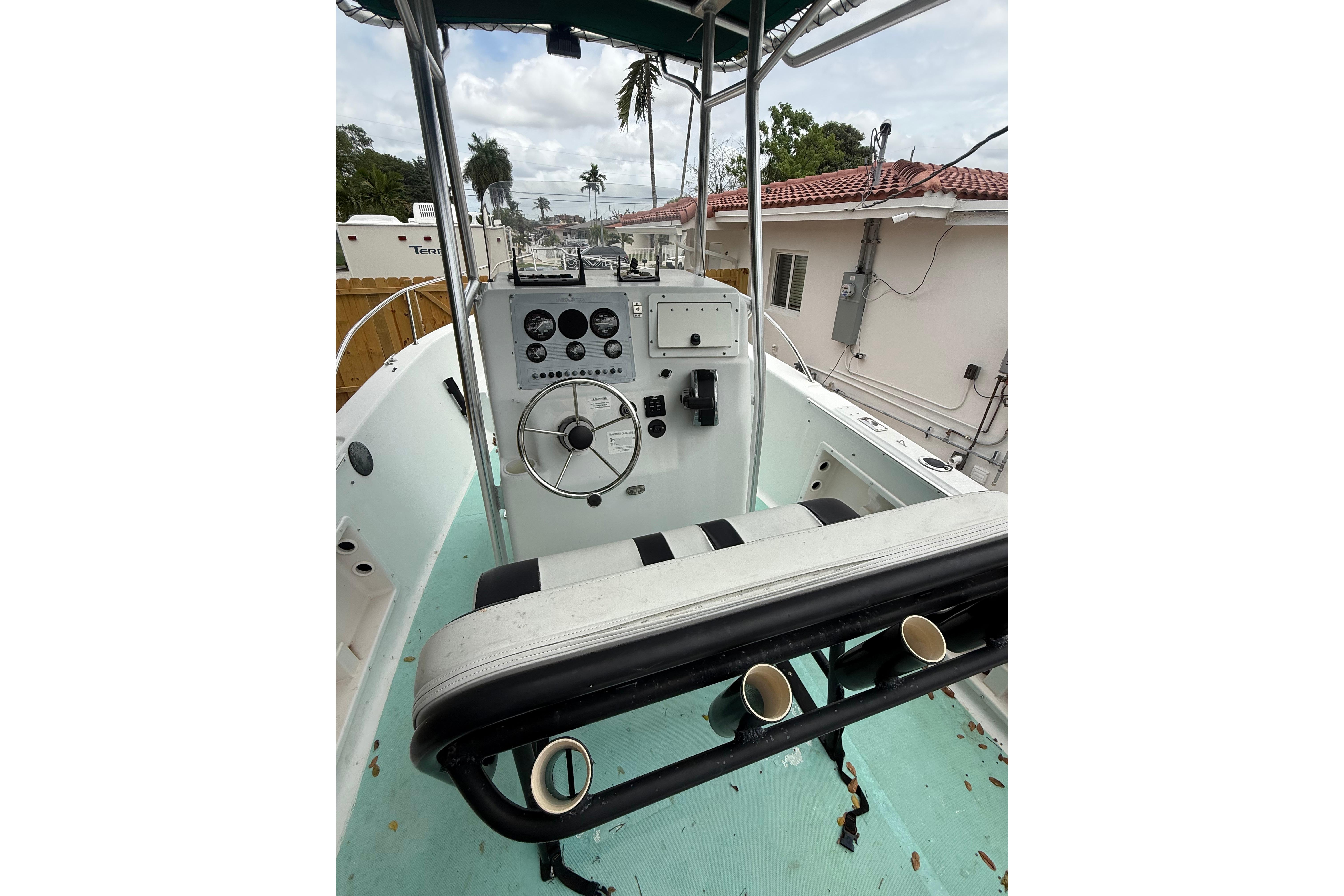2005 LYG Sea Fox boat cockpit with steering wheel and control panel.