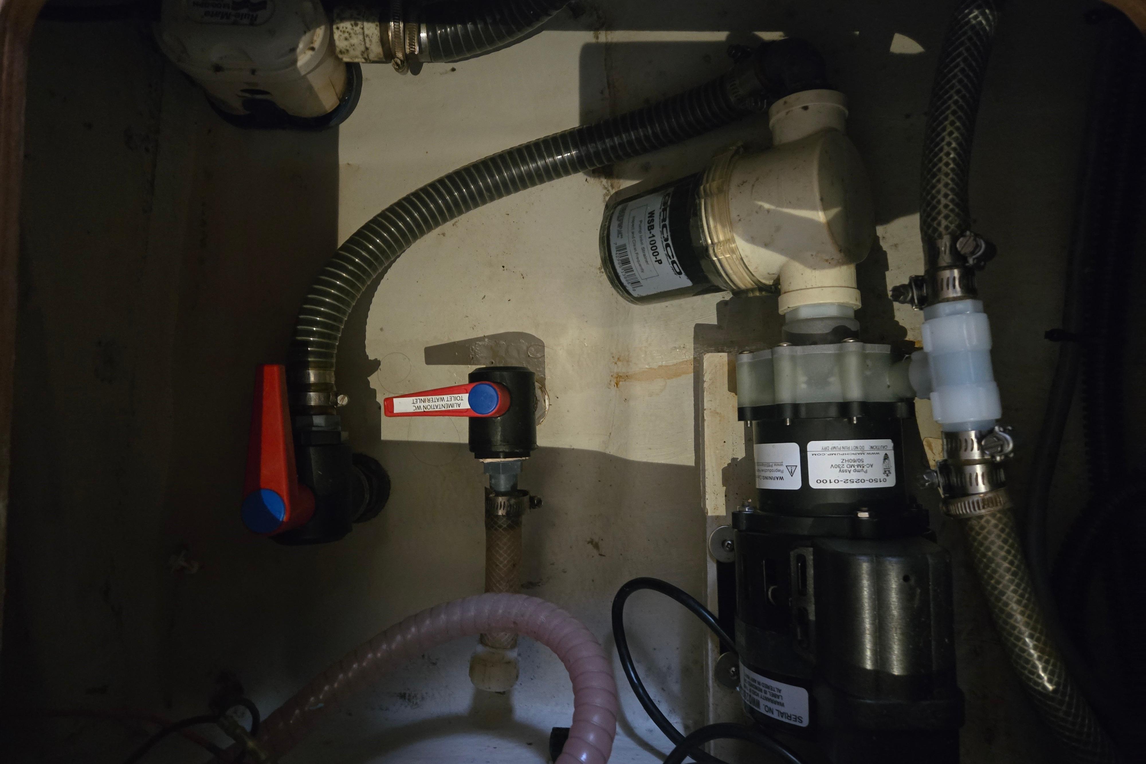 Engine compartment of a 2018 Fountaine Pajot Helia 44 Evolution catamaran, showing plumbing and valves.
