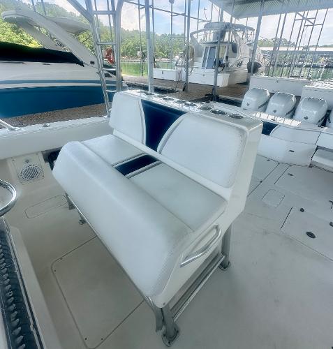 2008 SeaVee 390B boat with white and blue seating, docked in a marina.