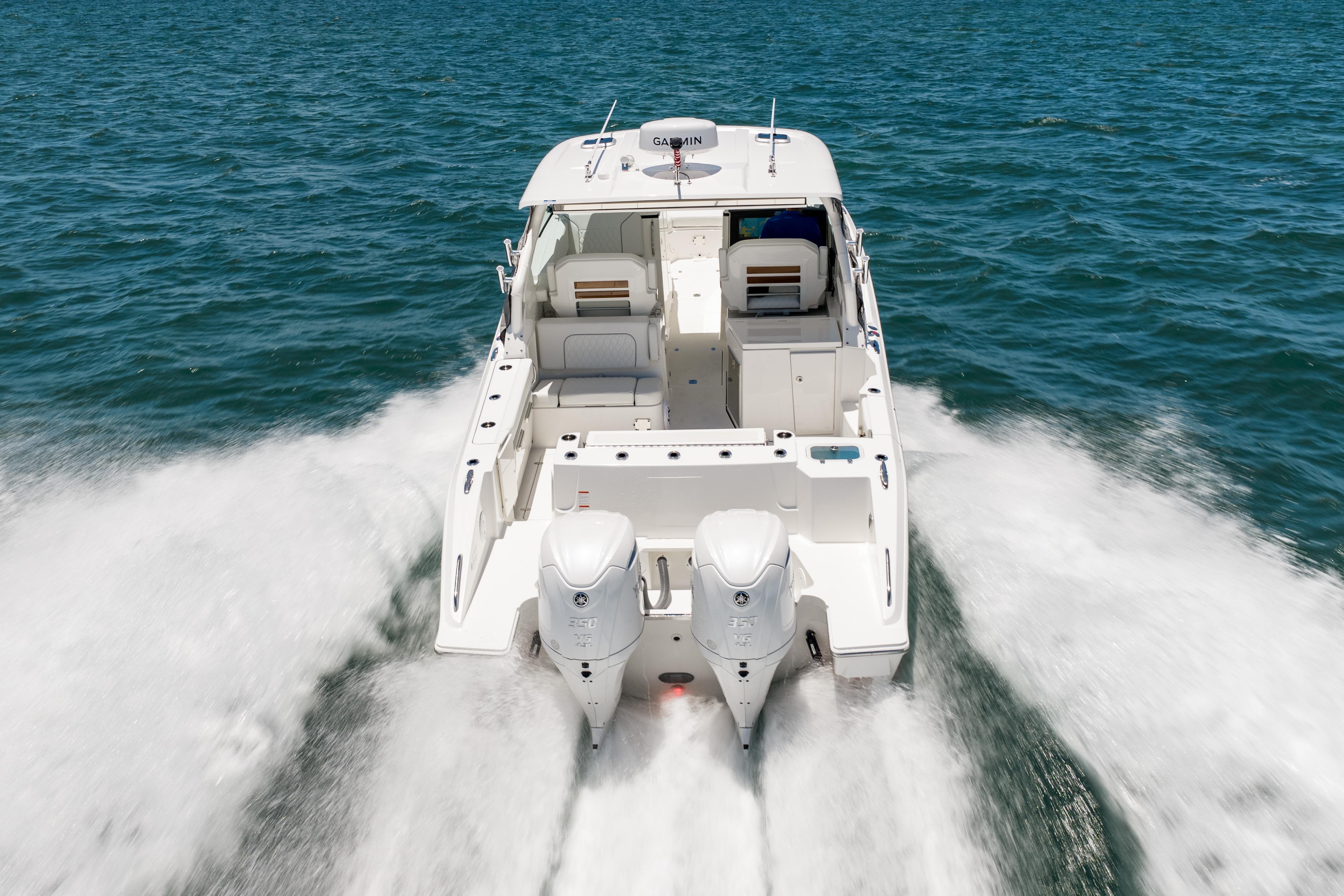 2026 Pursuit DC 326 Dual Console boat cruising on open water.