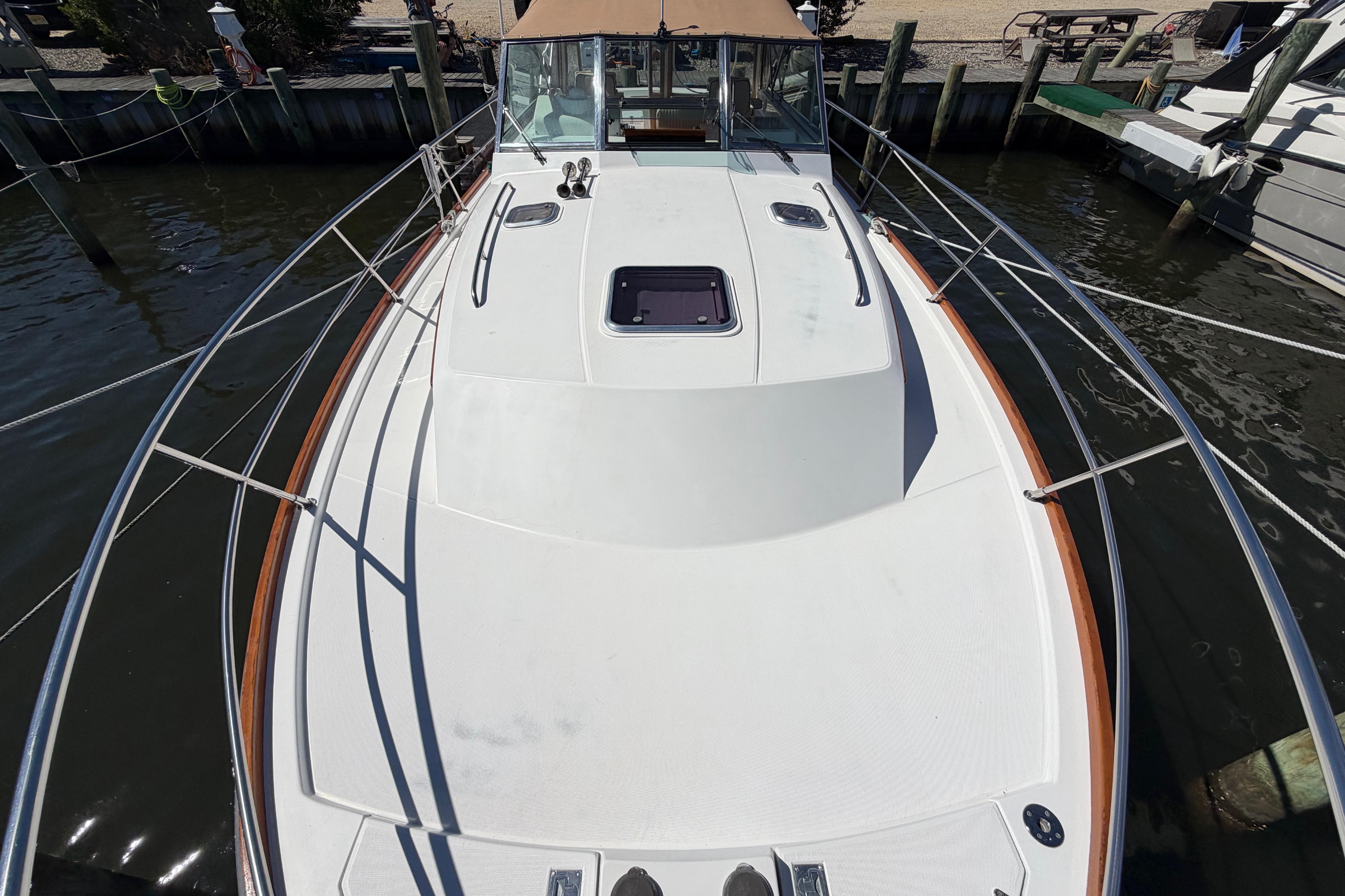 2000 Sabreline 36 Express boat docked, showcasing spacious deck and sleek design.