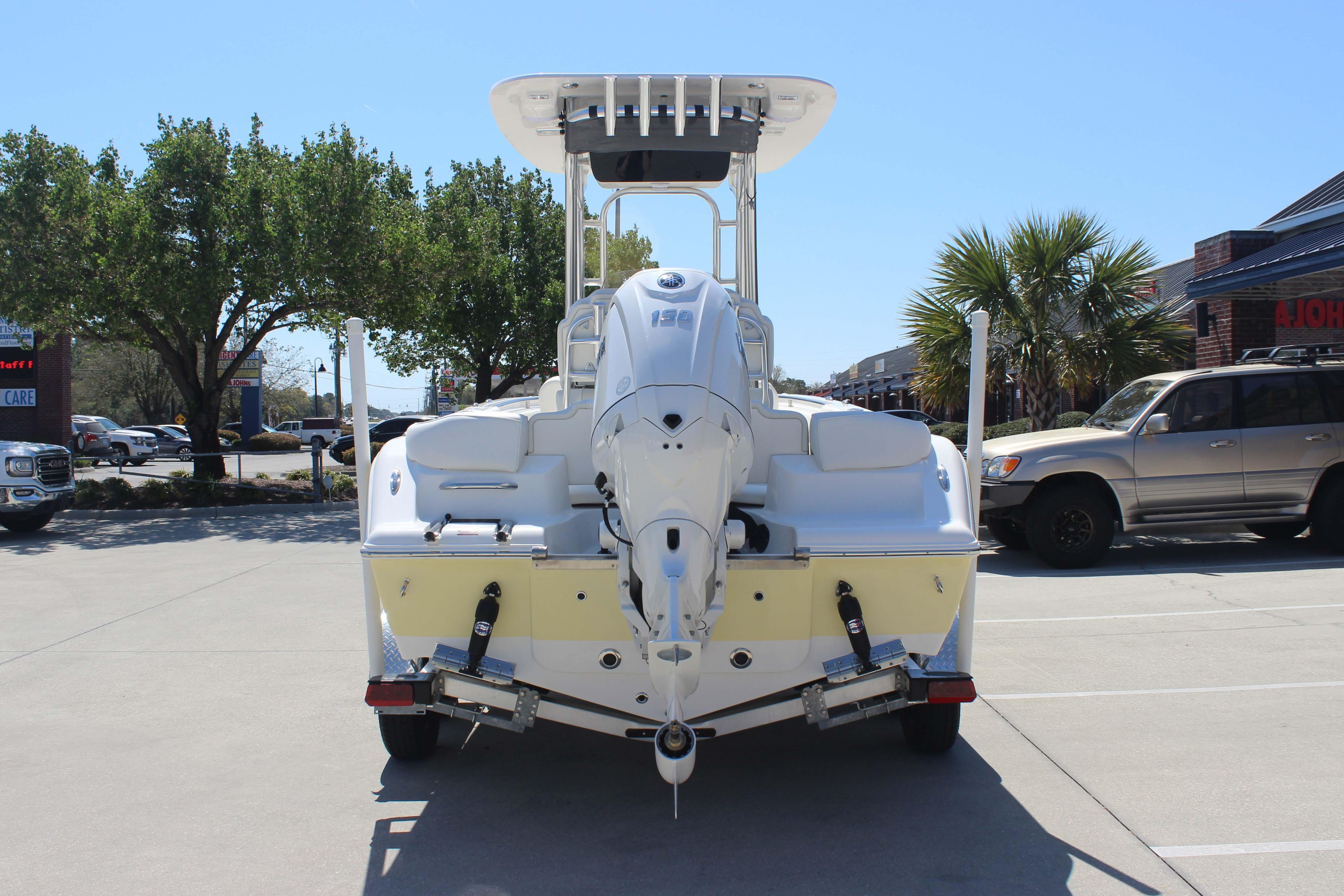 2026 Key West 203 FS boat on trailer in parking lot, sunny day.
