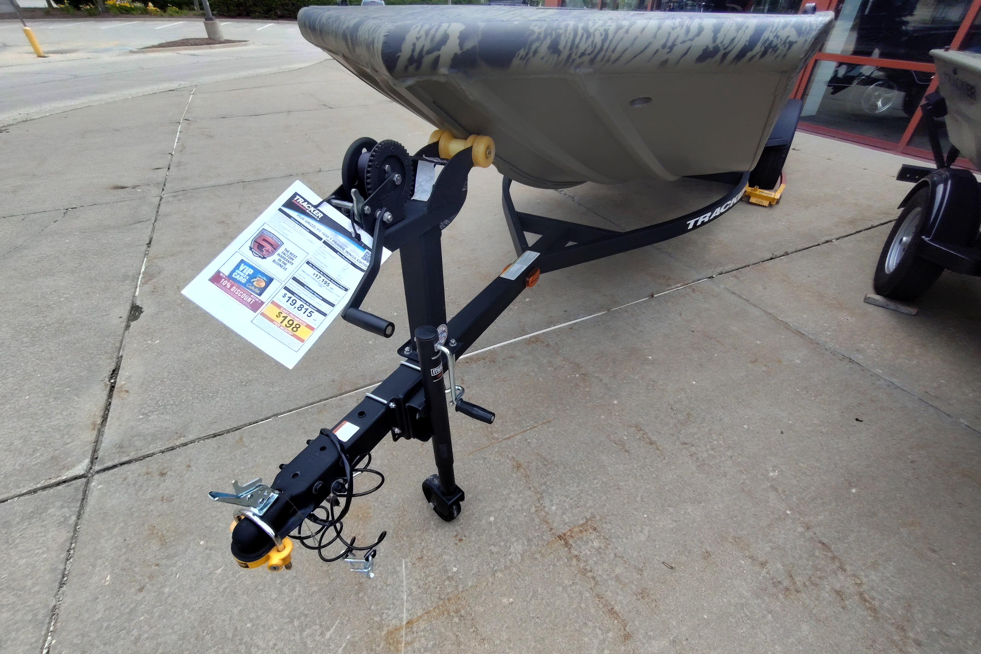 2026 Tracker Grizzly 1650 T Prairie Wings Edition boat on trailer, displayed outdoors.