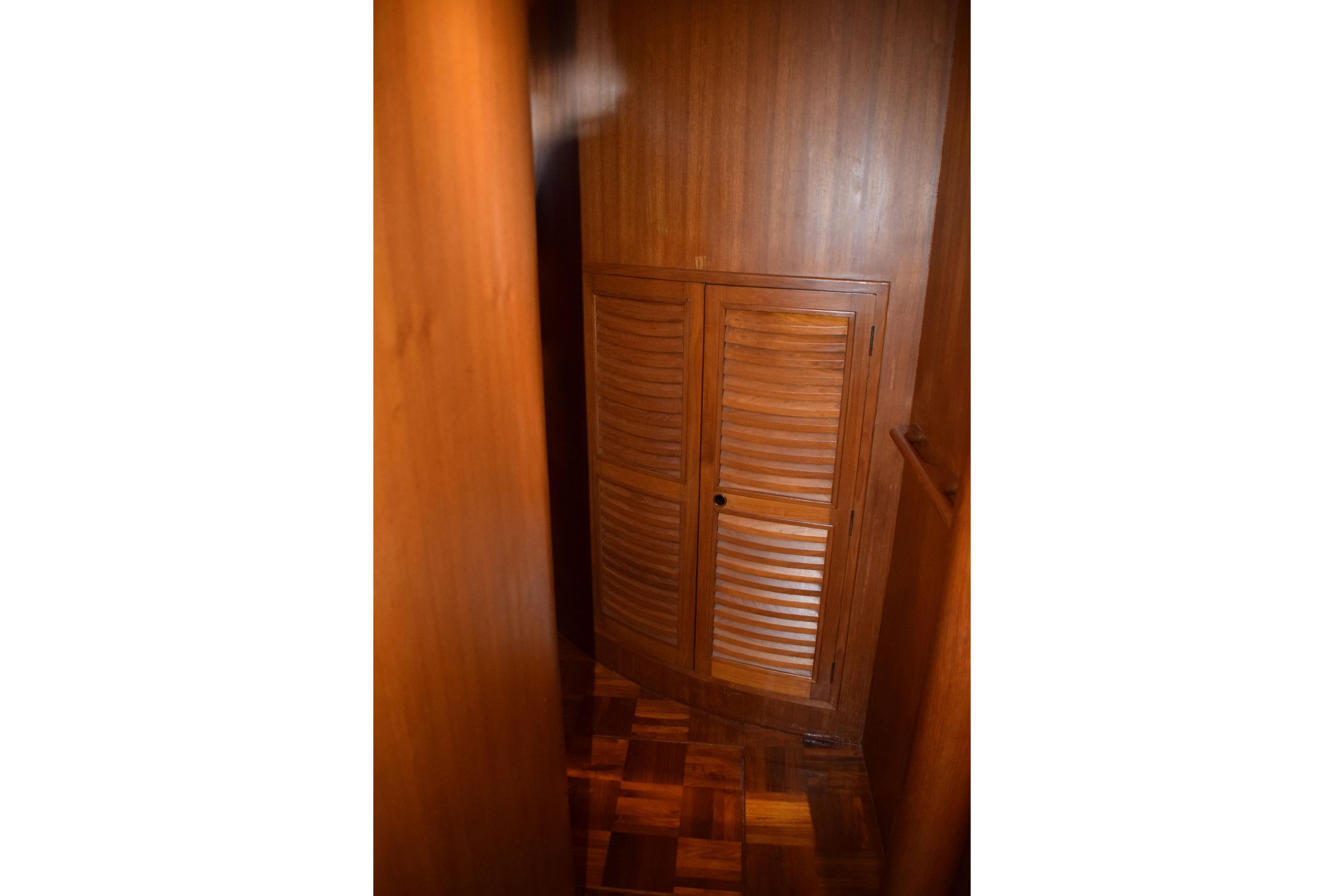 Wooden interior of 1980 Cheoy Lee 52 Motorsailer, featuring louvered cabinet doors.