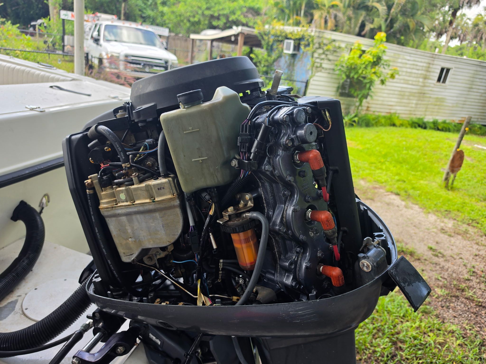 An open outboard motor of a boat showing various components and wiring.
