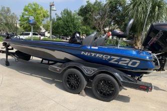 2026 Nitro Z20 XL boat on trailer, blue and black design, parked outdoors.