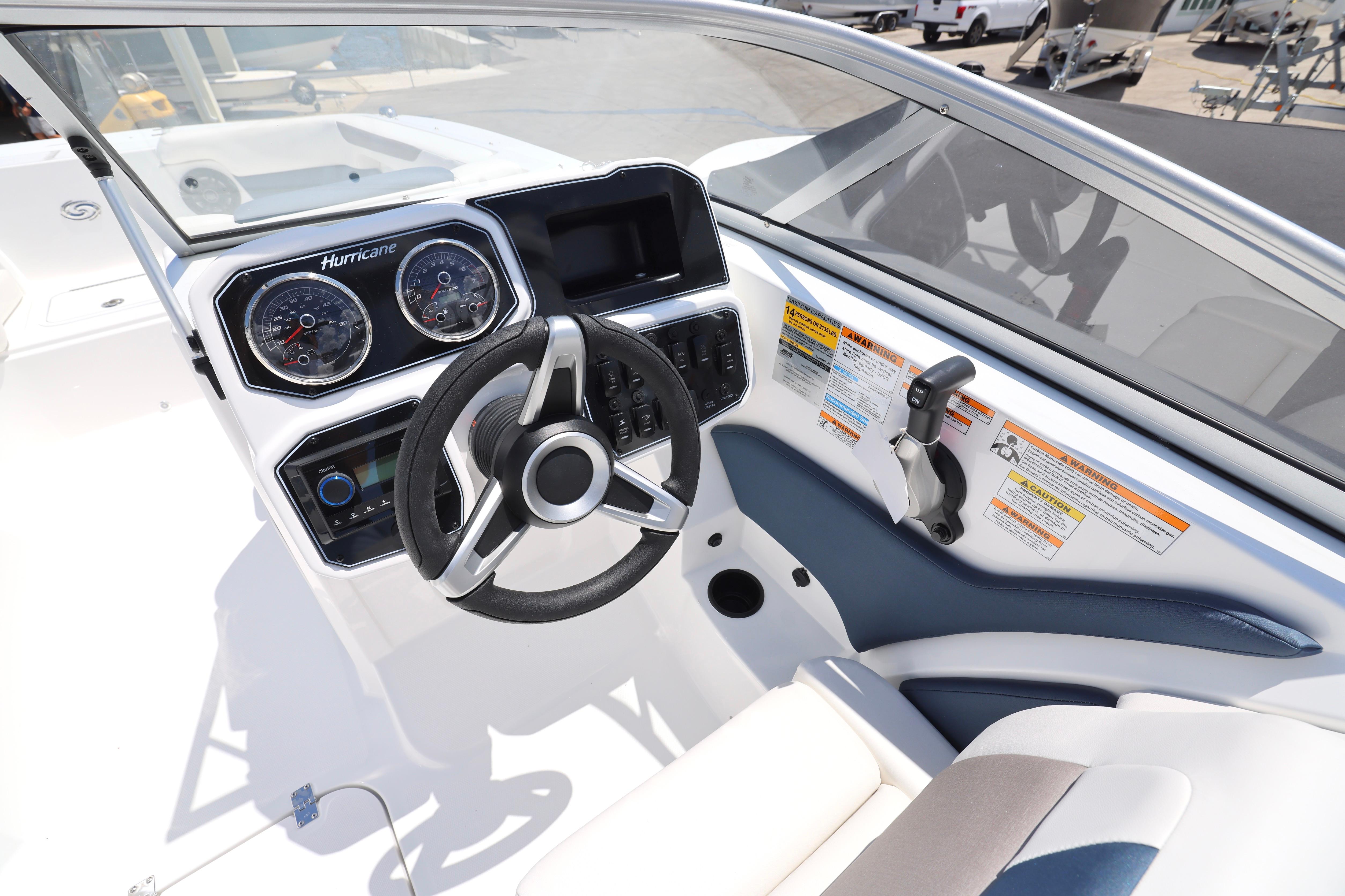 2026 Hurricane SunDeck 2050 OB boat dashboard with steering wheel and control panel.