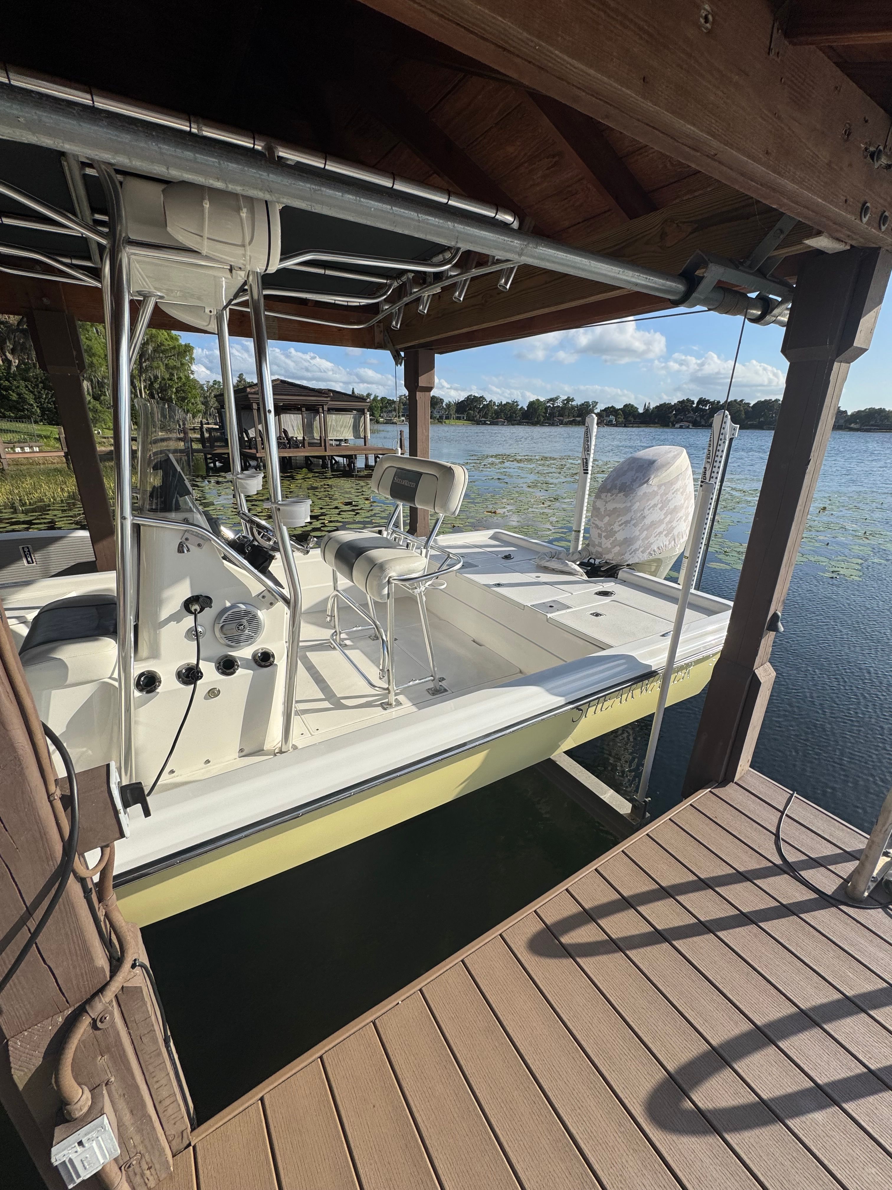2004 ShearWater LTZ boat docked with scenic lake view.