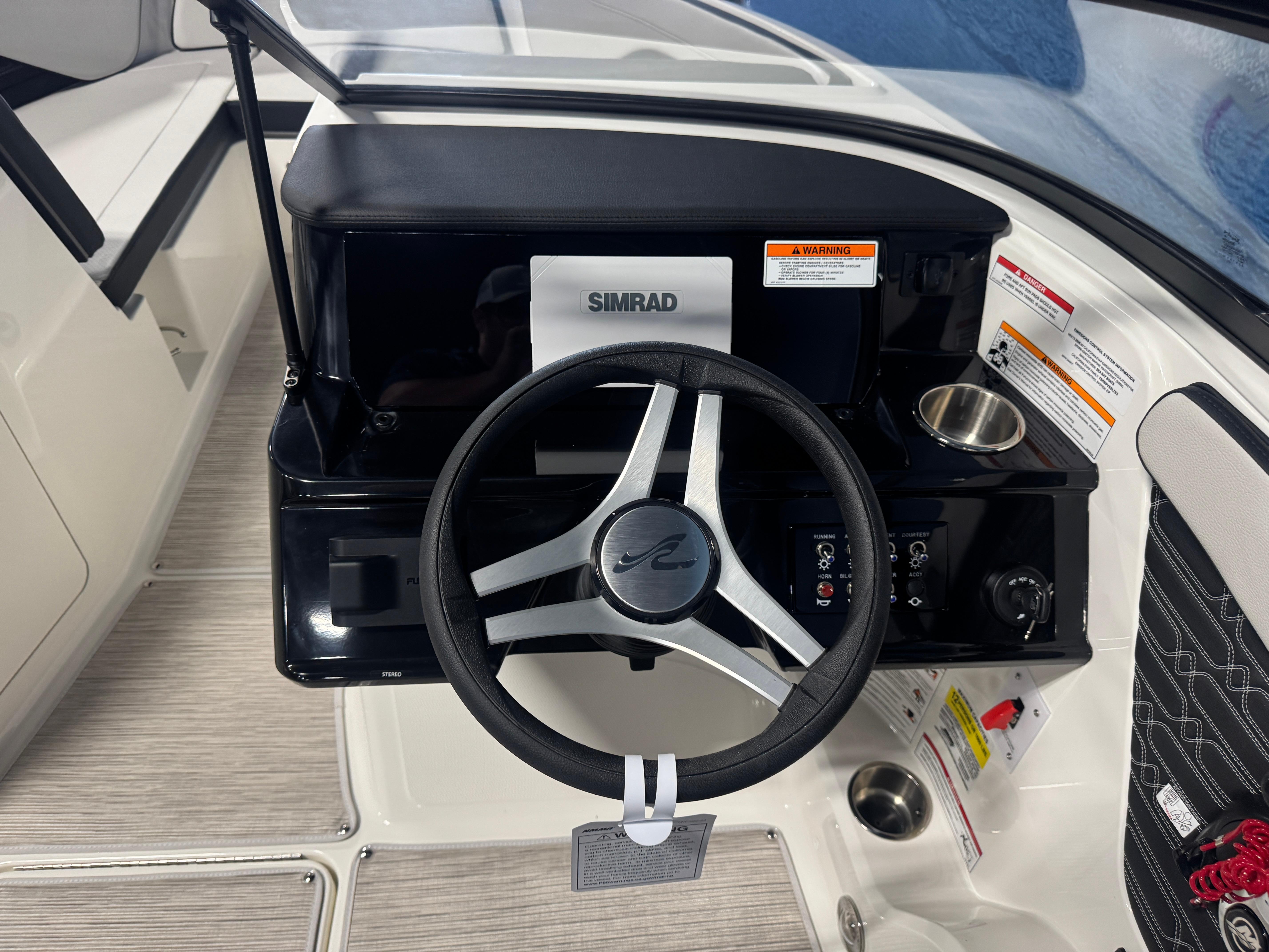 2026 Sea Ray SPX 210 boat dashboard with steering wheel and Simrad display.