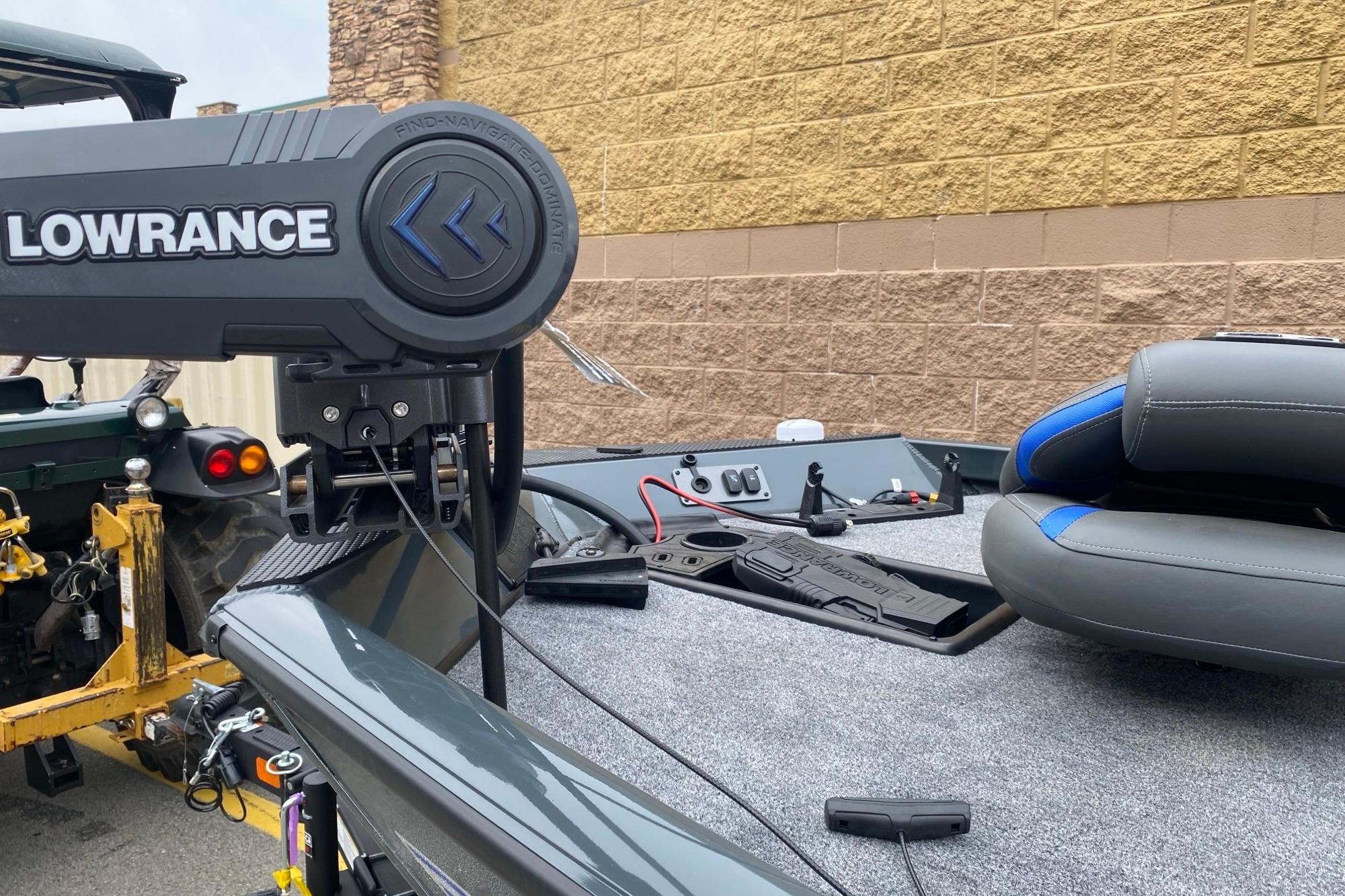 2026 Ranger RT178 boat with Lowrance equipment, parked near a brick wall.