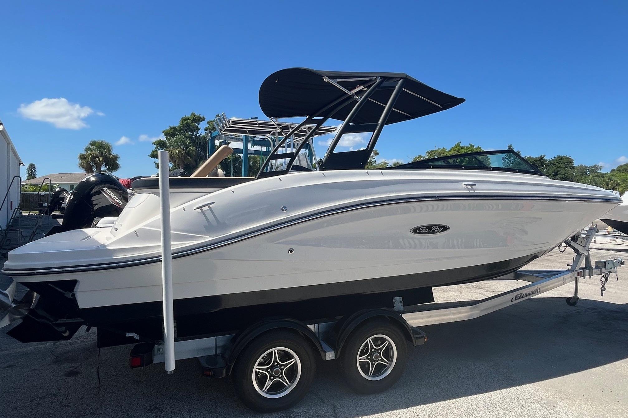 2024 Sea Ray SPX 230 boat on trailer, featuring sleek design and black canopy.