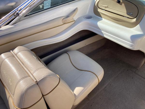 2001 Sea Ray 180 Bow Rider interior with beige seating and storage compartment.
