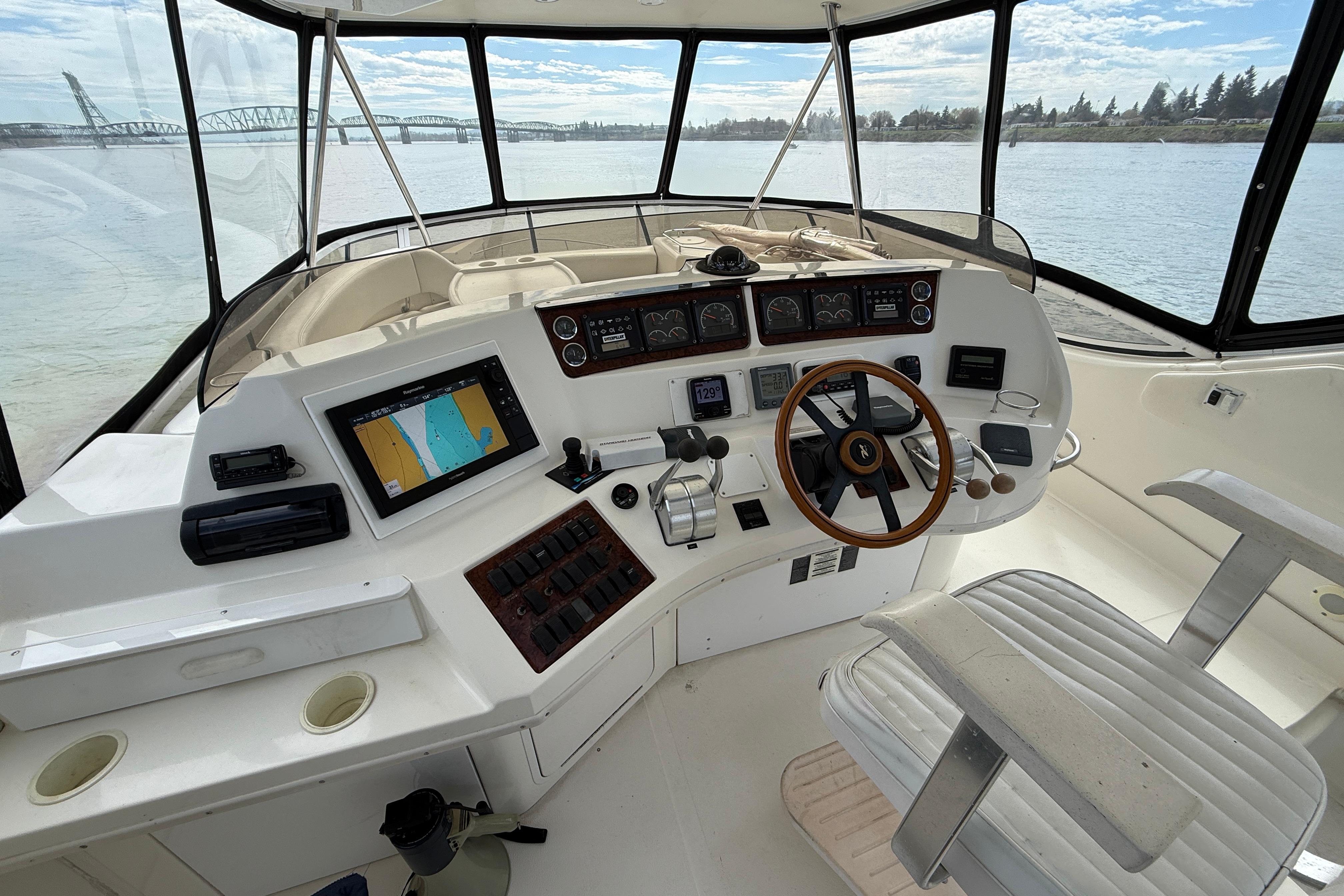1999 Sea Ray 560 Sedan Bridge helm with navigation equipment and panoramic water view.