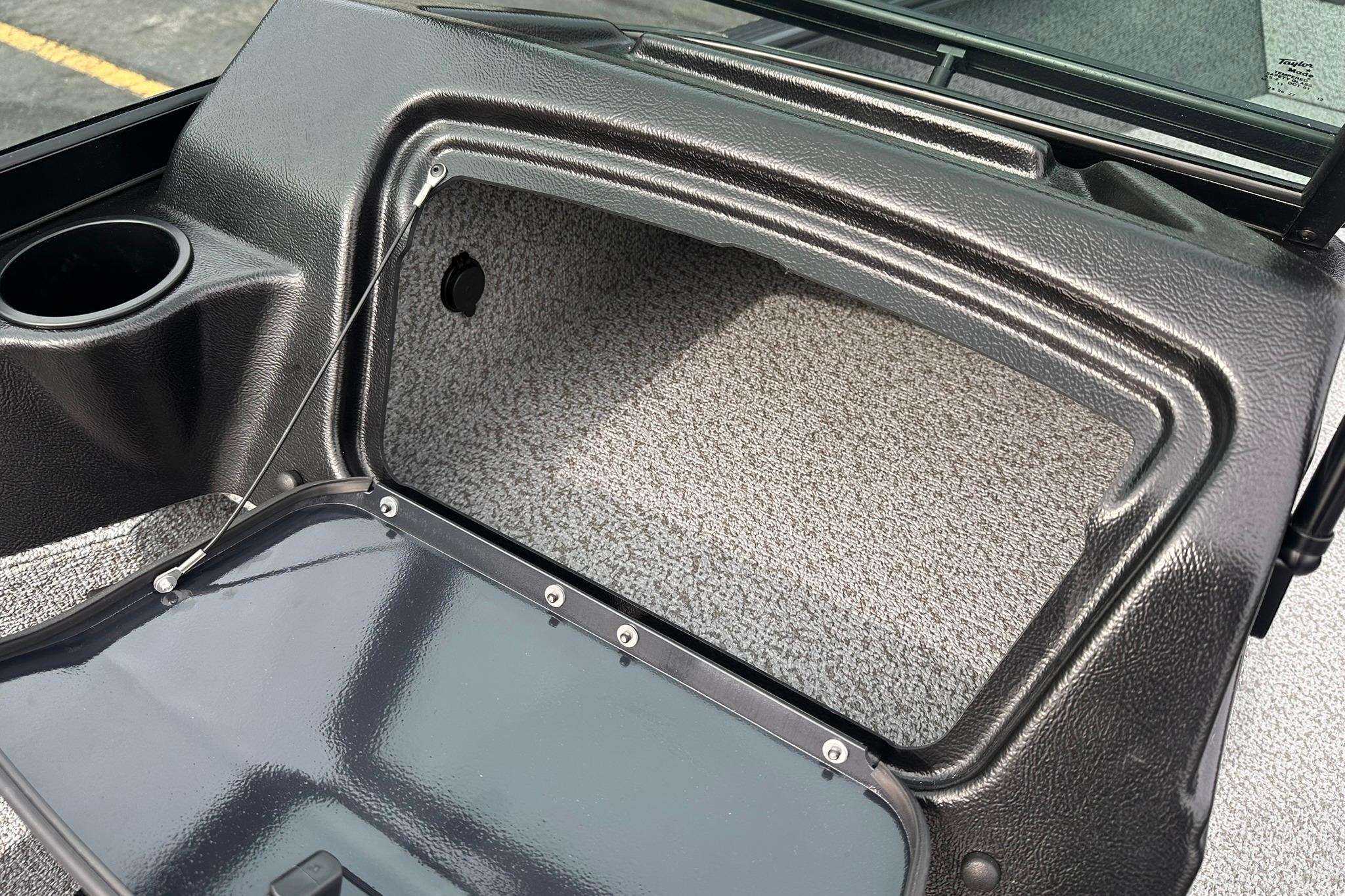 Open storage compartment in 2026 Lund 1775 Adventure Sport boat interior.