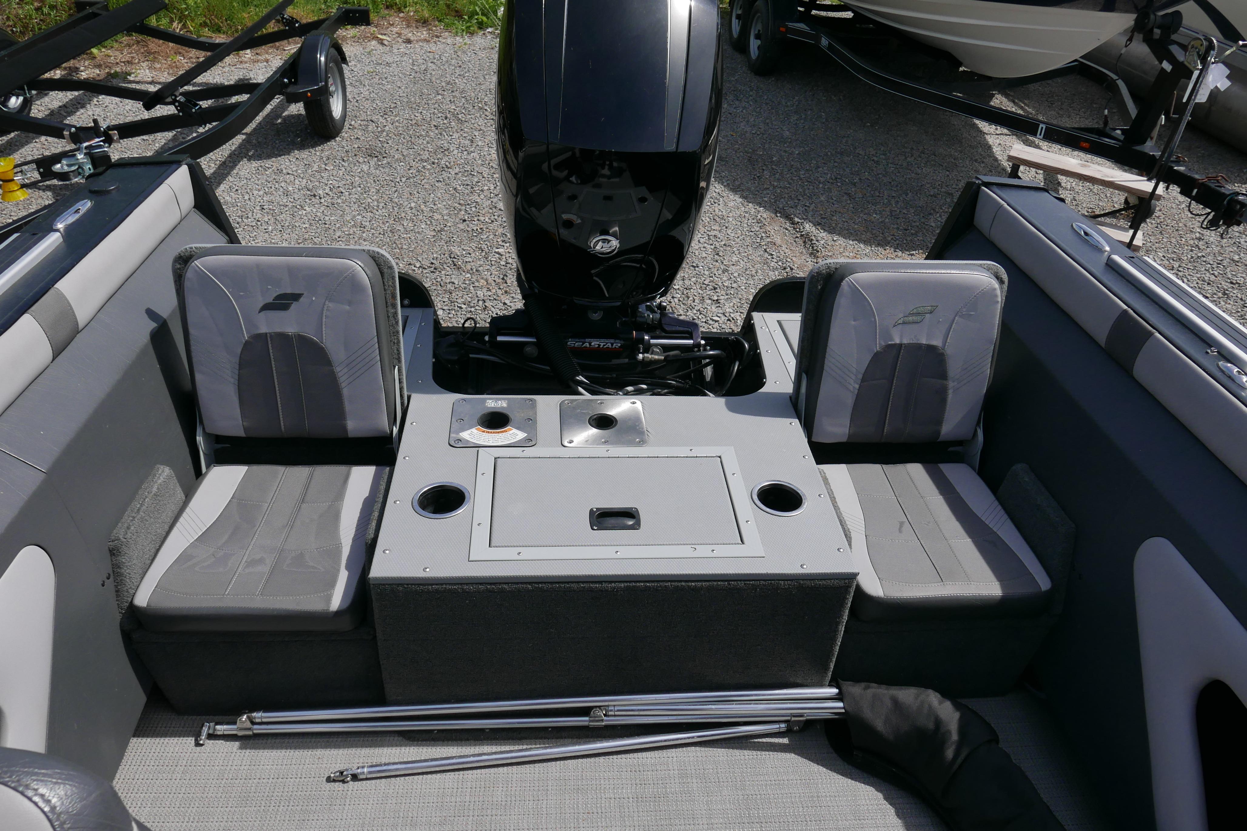2016 Starcraft Titan 186 boat interior with seating and motor, parked on gravel.