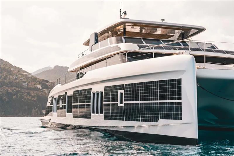 2026 Sunreef 80 Sunreef Power yacht with solar panels on calm water.