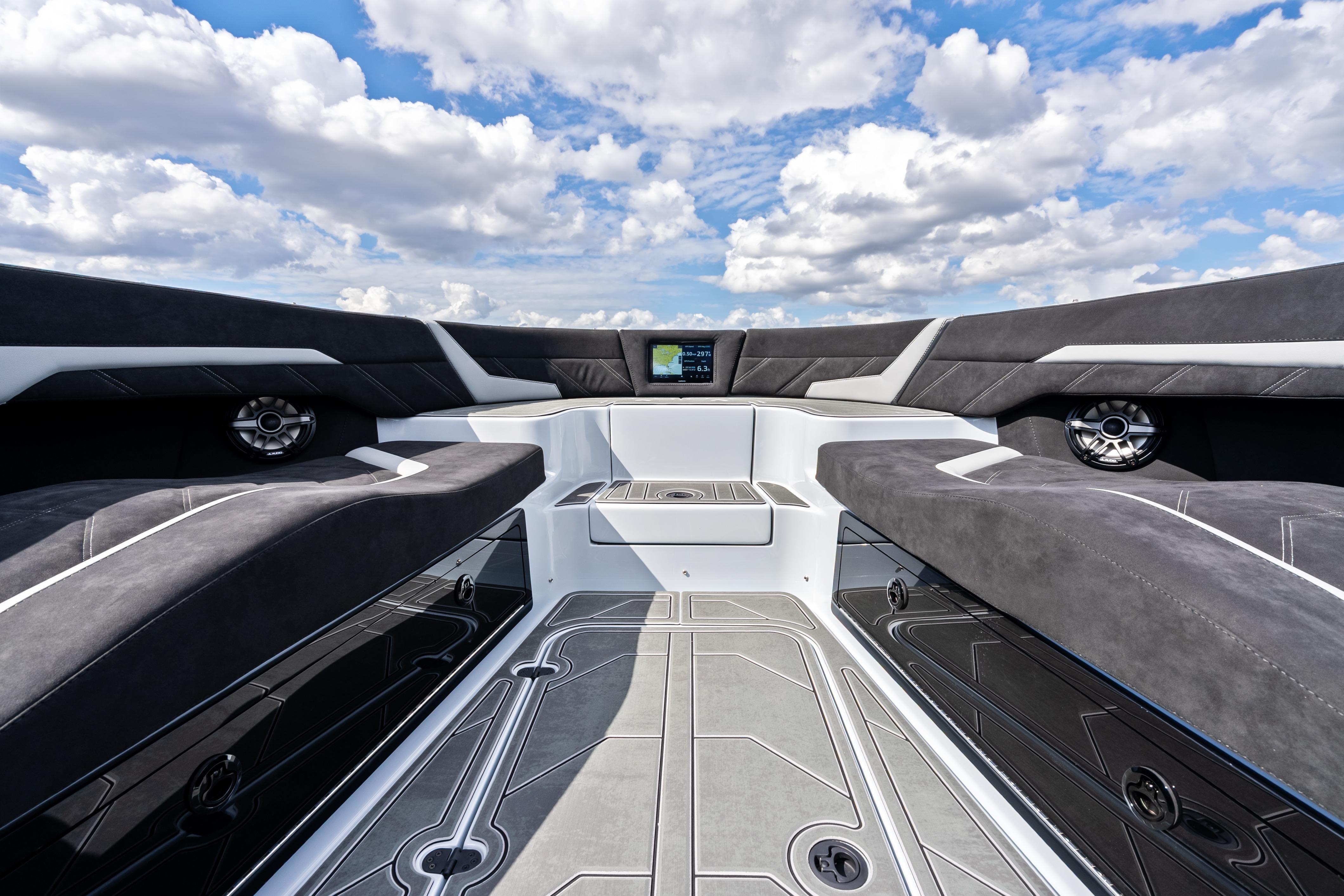 Interior of 2027 Mystic Powerboats M4200, featuring sleek seating and modern design under a blue sky.