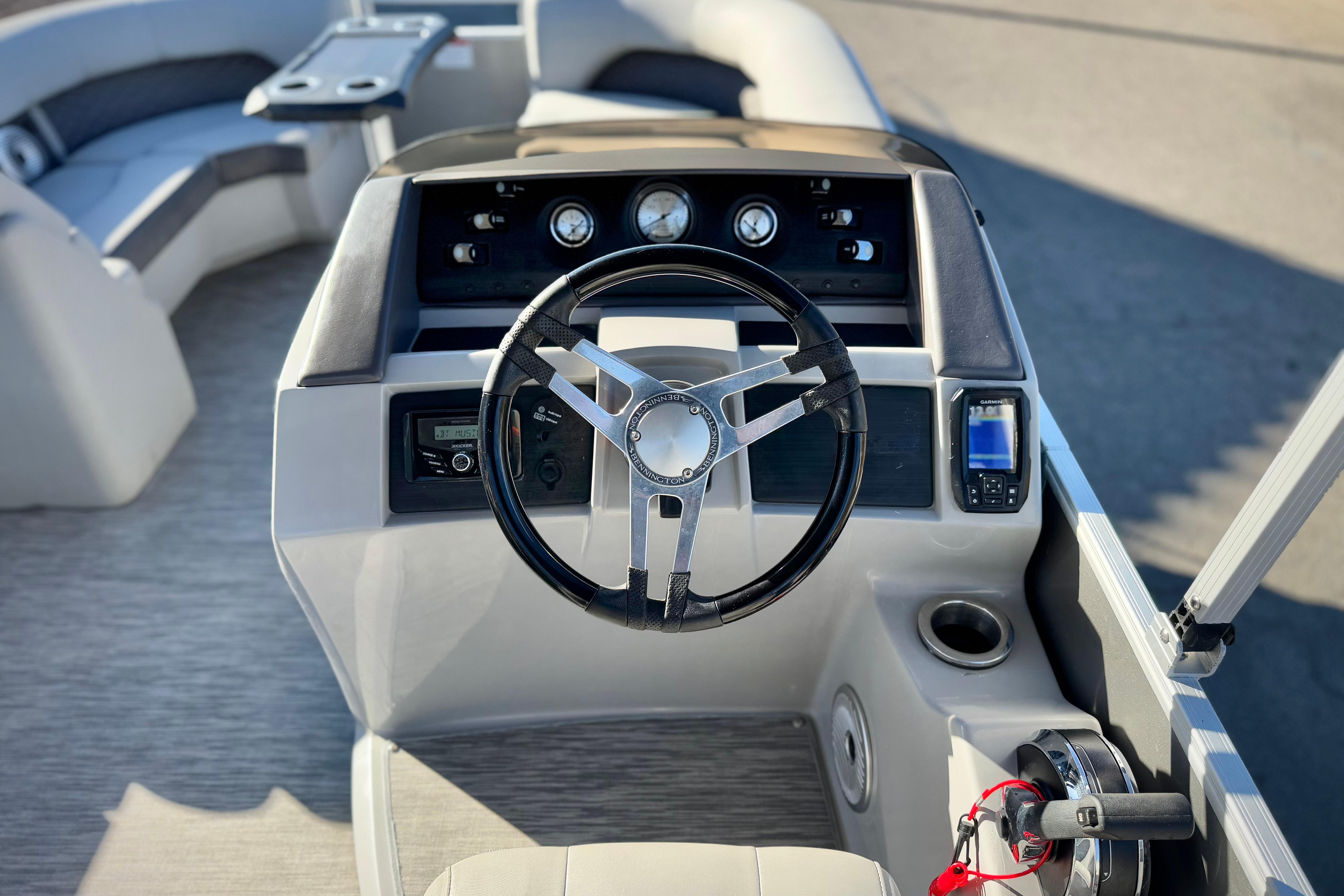 2021 Bennington 23LSR boat dashboard with steering wheel and navigation controls.