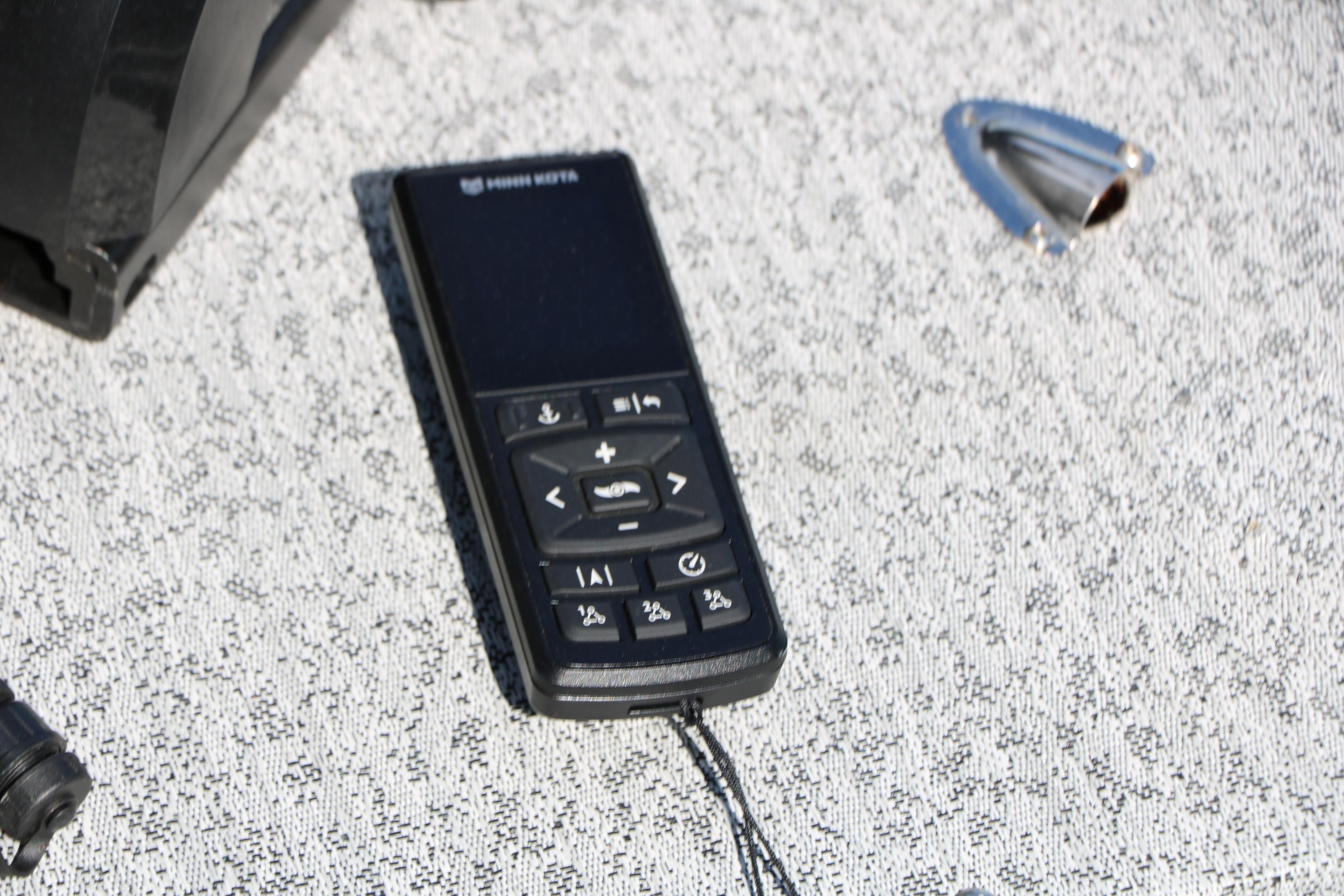 Remote control on Smoker Craft Adventurer 188 DC boat, 2025 model, on textured surface.