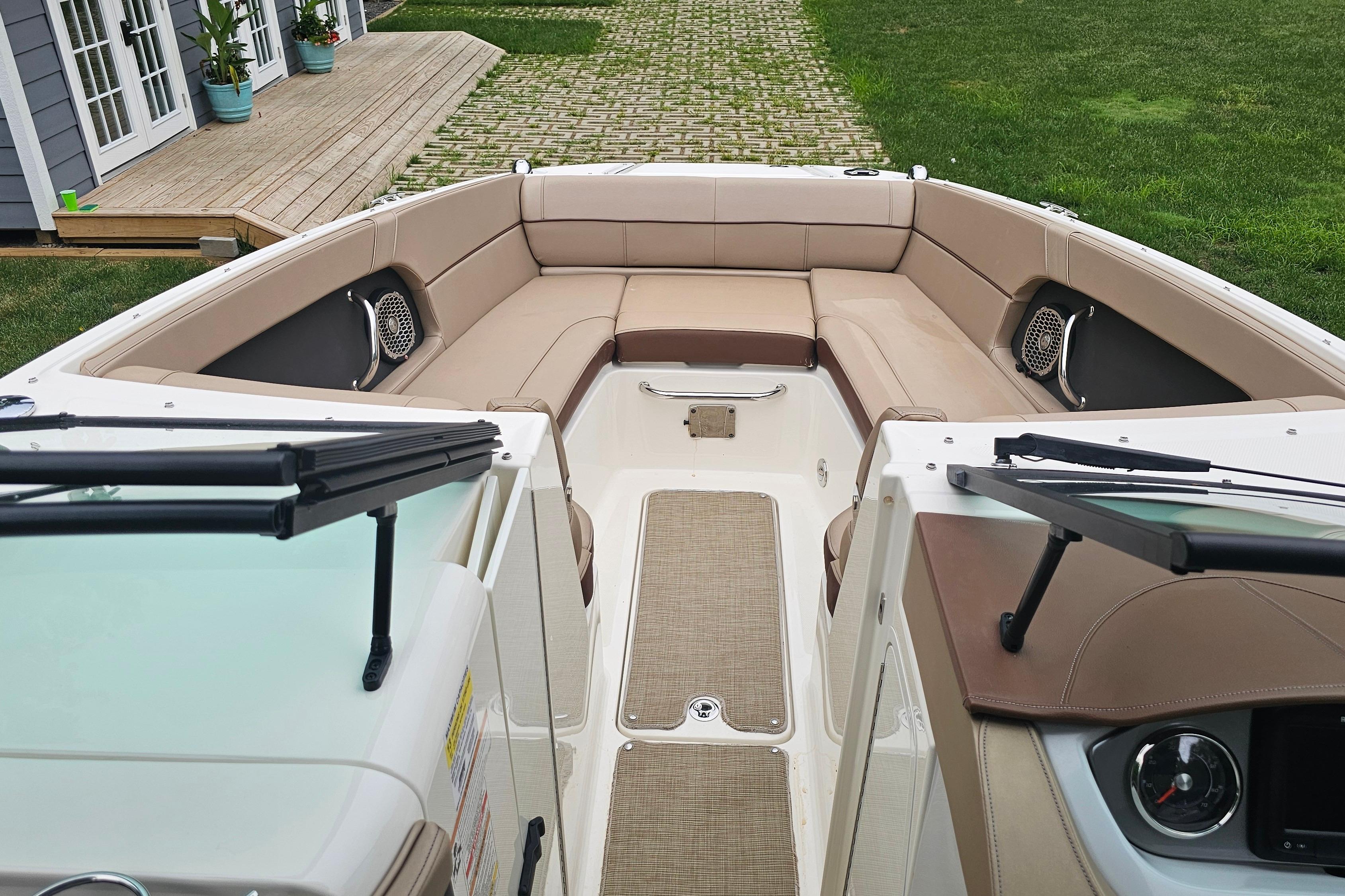 2017 Sea Ray SDX 240 Outboard boat interior with beige seating and modern dashboard.