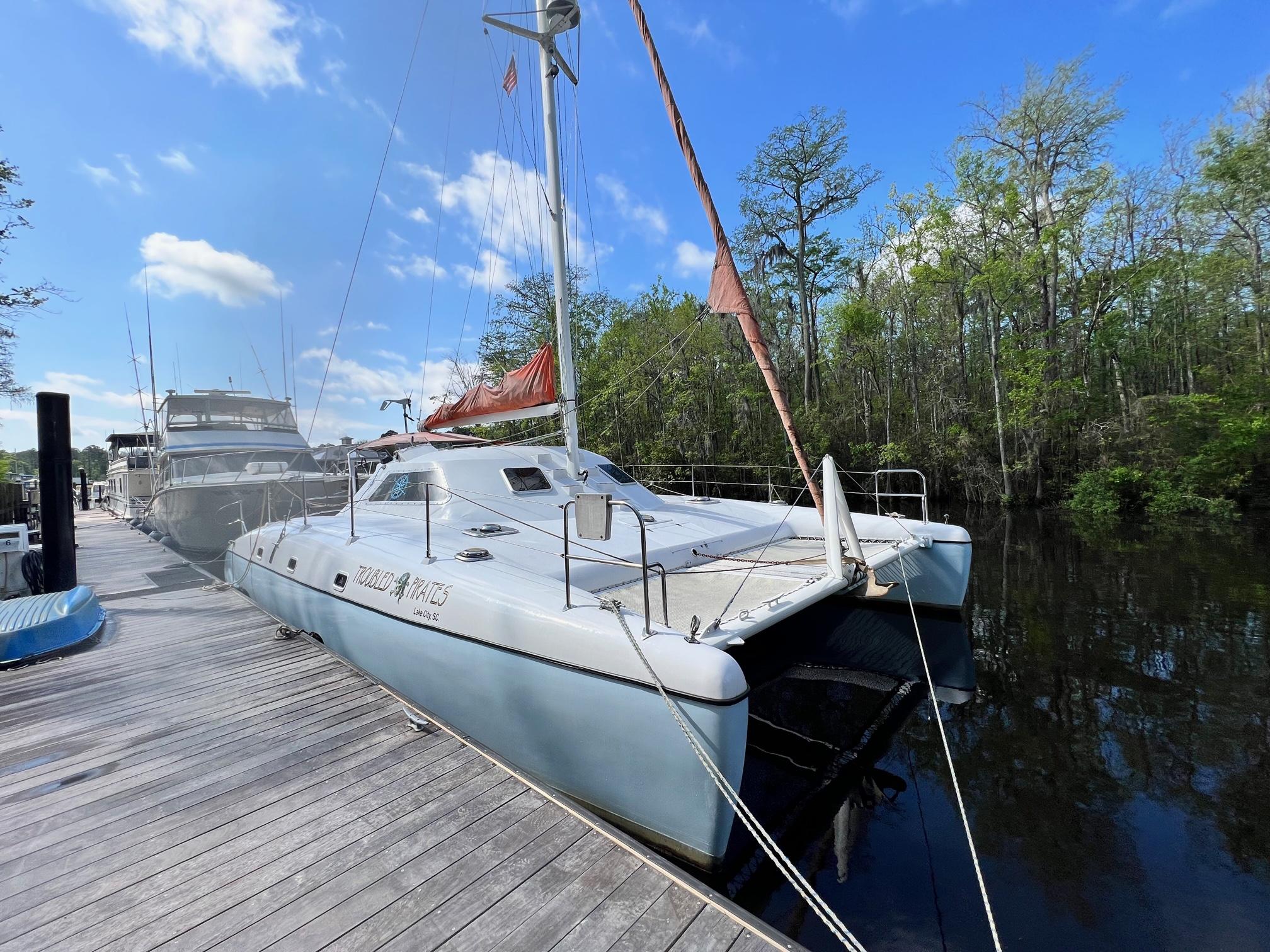 1999 Wildcat 35 Catamaran docked at a marina on a sunny day.