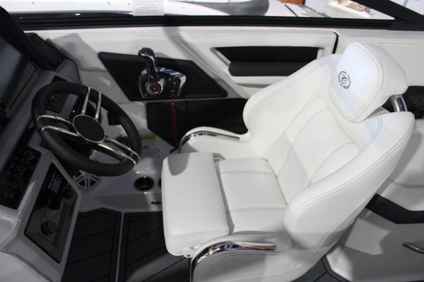 2025 Cobalt R6 boat interior with white captain's seat and modern steering wheel.