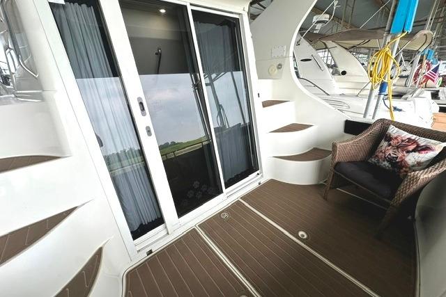 2004 Carver 360 Mariner yacht interior with sliding glass doors and seating area.