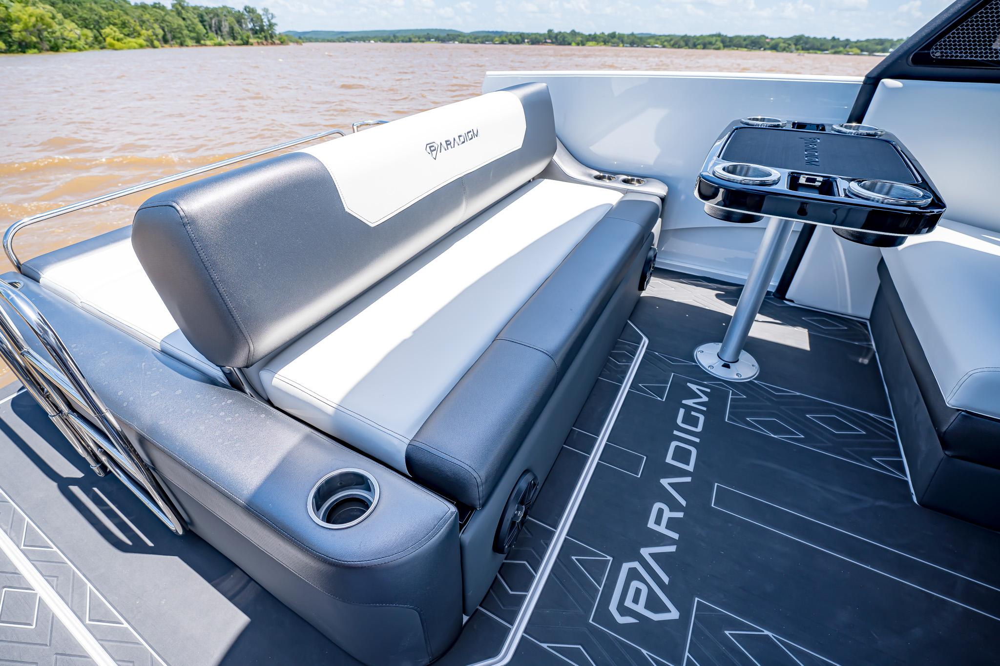 Luxury seating on 2025 Paradigm Damascus 266 Surf boat, featuring sleek design and cup holders.