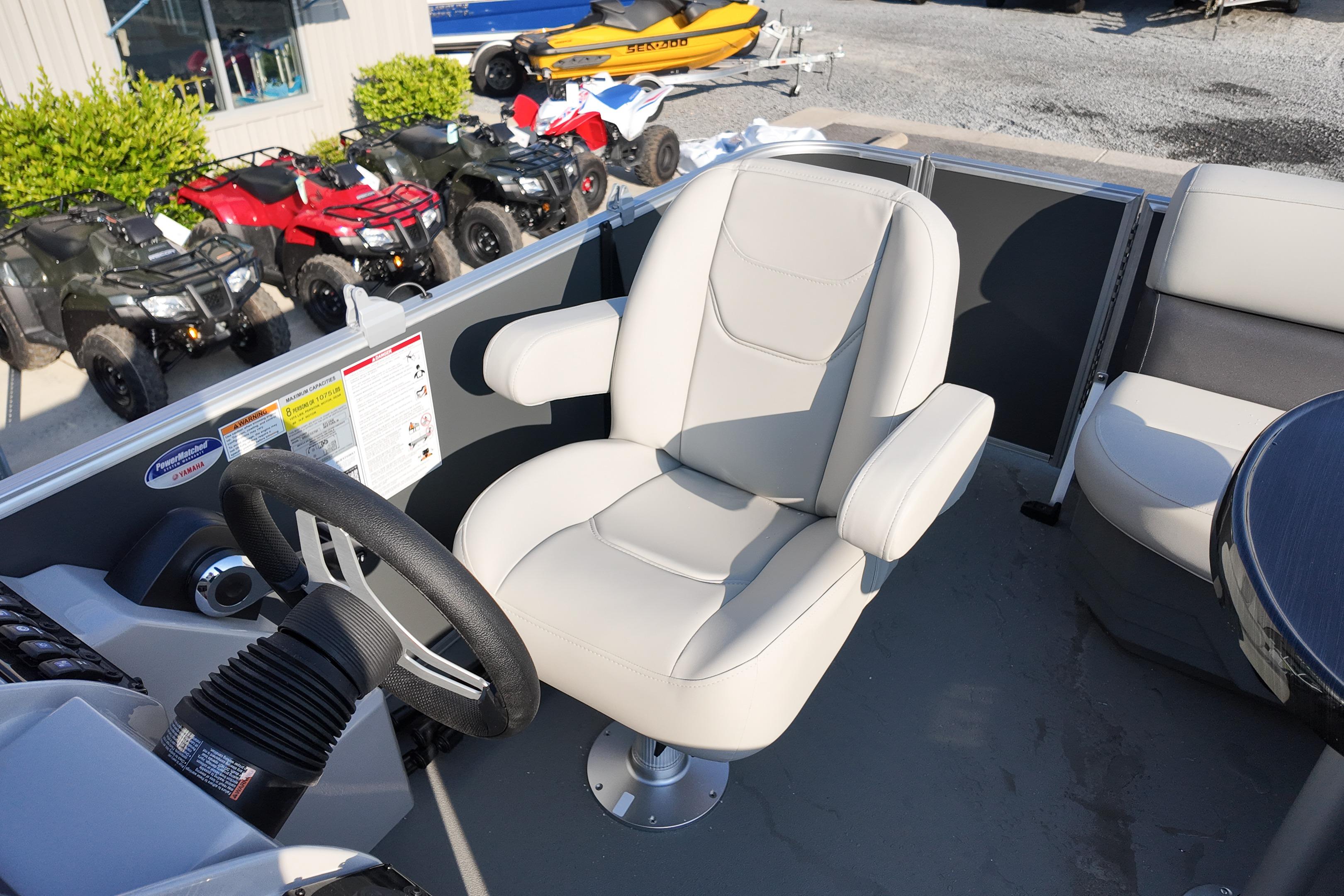 2026 Sylvan Mirage 818 Fish boat interior with steering wheel and comfortable seating.