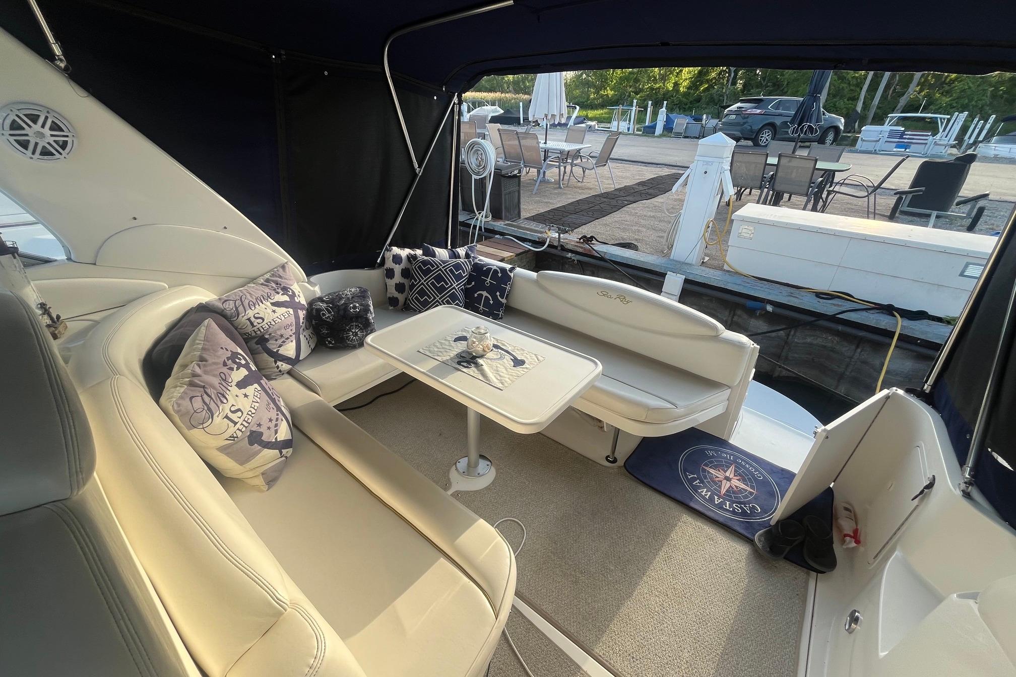Interior of 2001 Sea Ray 340 Sundancer yacht with seating and nautical-themed decor.