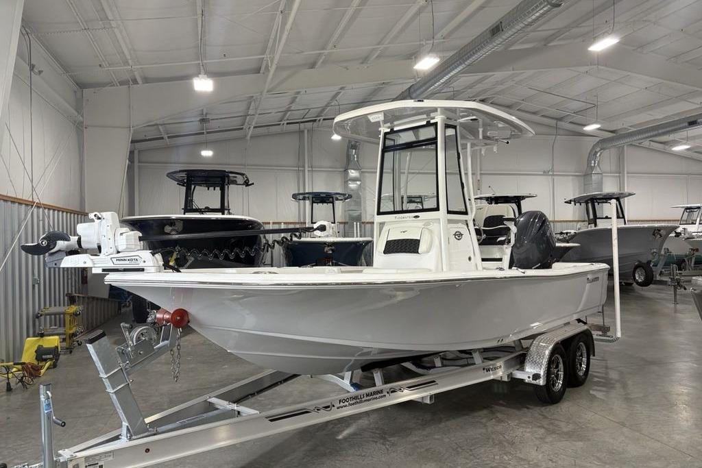 2026 Tidewater 2210 Carolina Bay boat on trailer in indoor showroom.