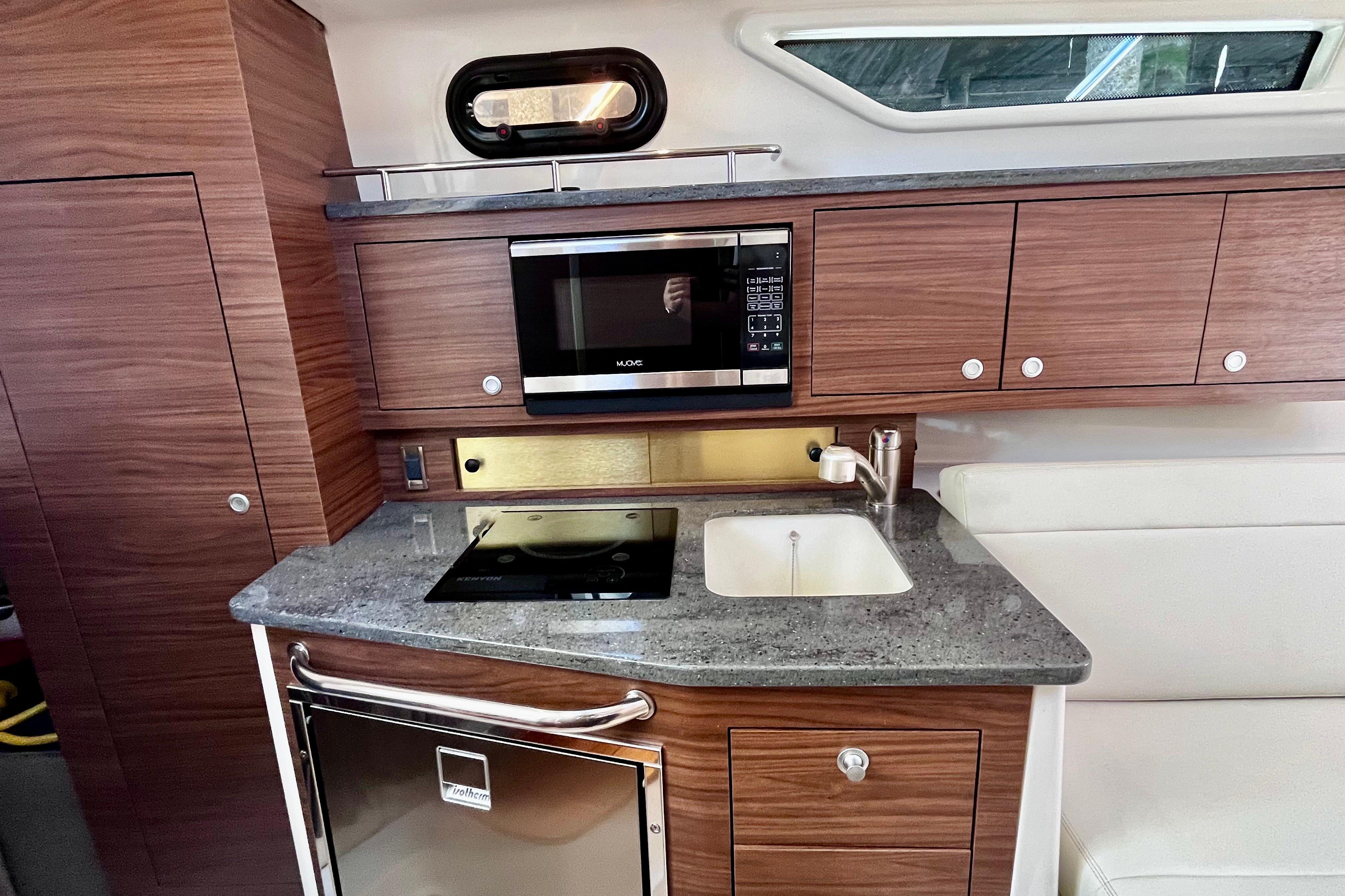 Modern kitchen area in 2026 Boston Whaler 325 Conquest Pilothouse boat.