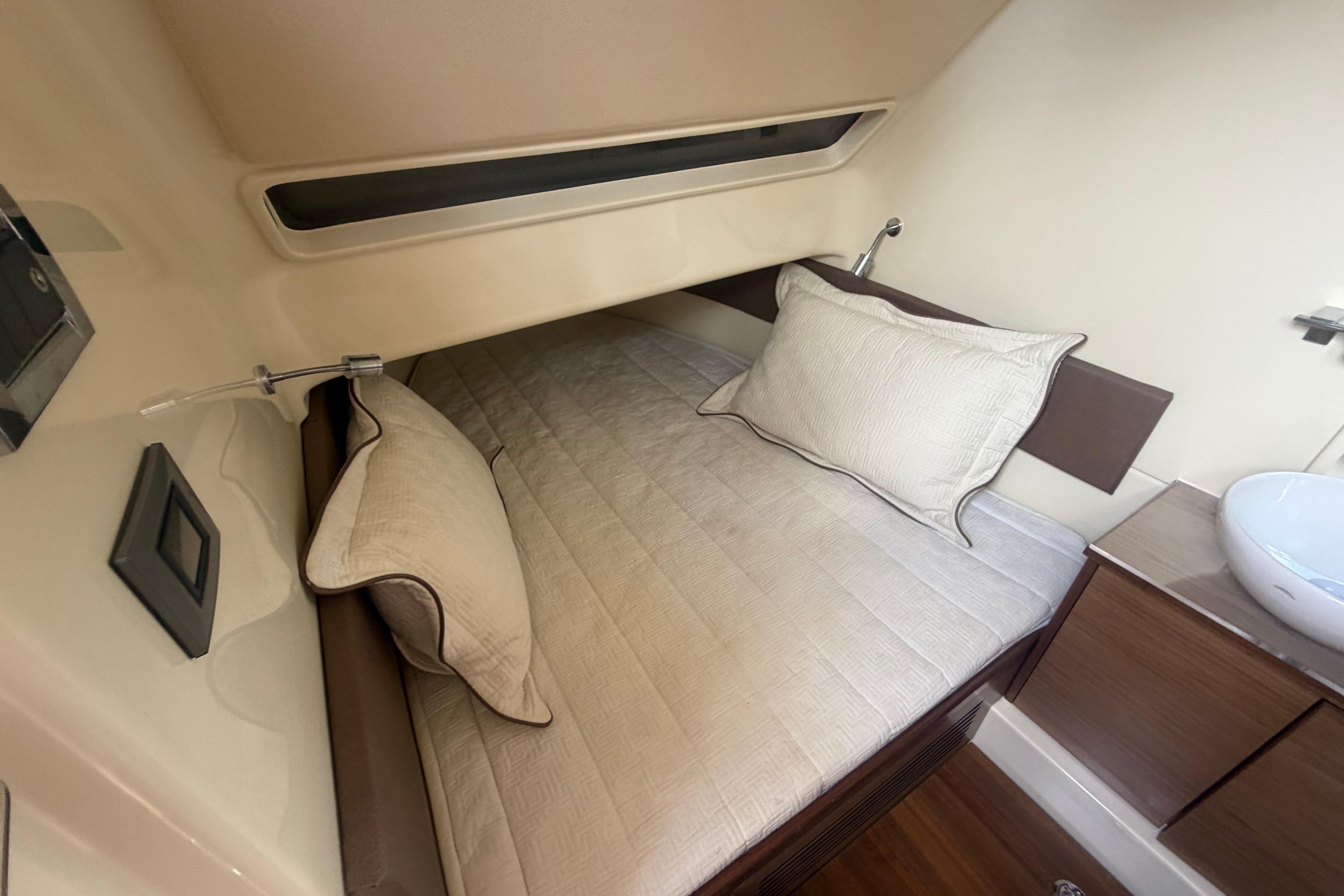 Cozy cabin interior of 2017 Chris-Craft Catalina 34 with bed and modern amenities.