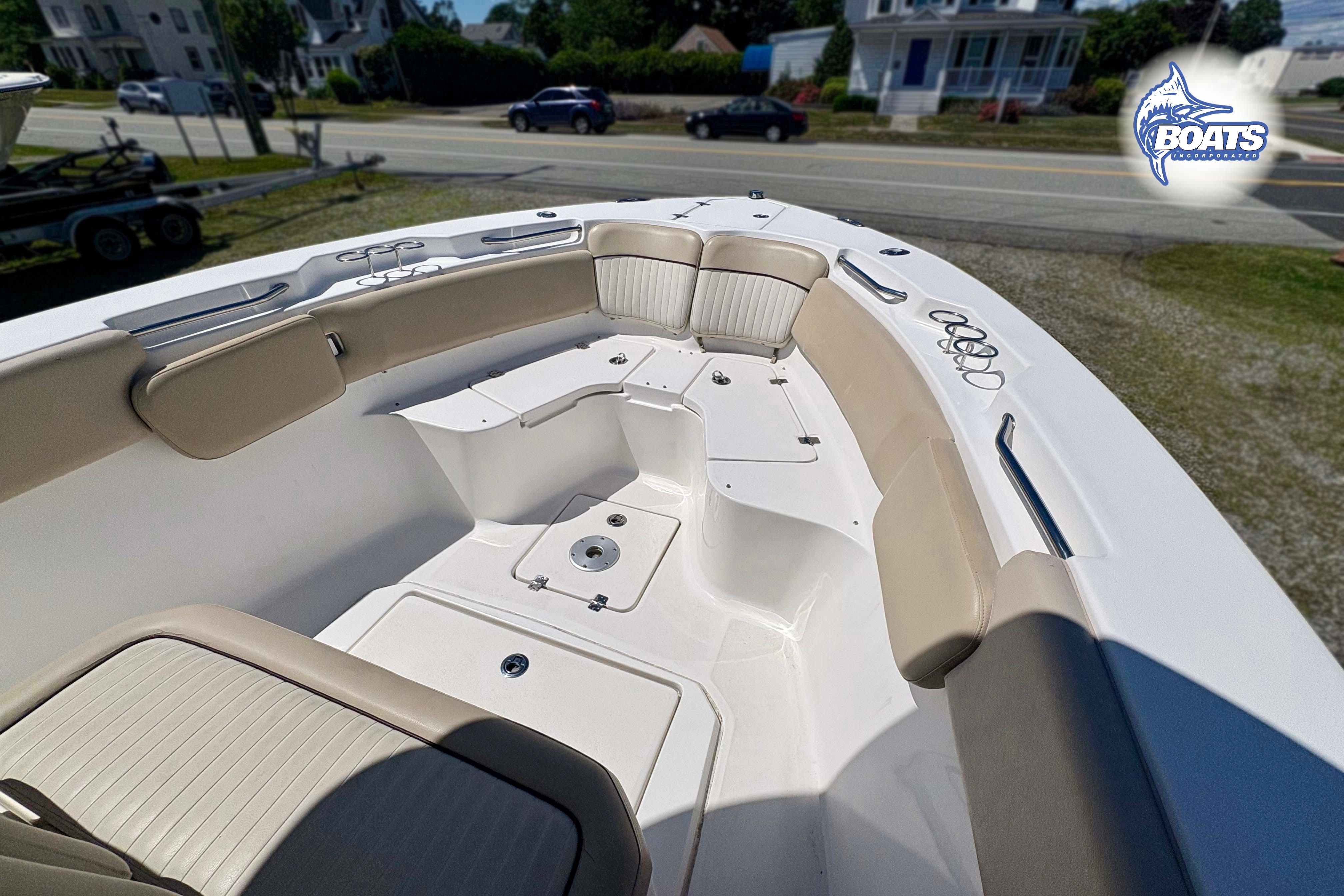 2015 Sea Fox 266 Commander boat interior with cushioned seating and storage compartments.