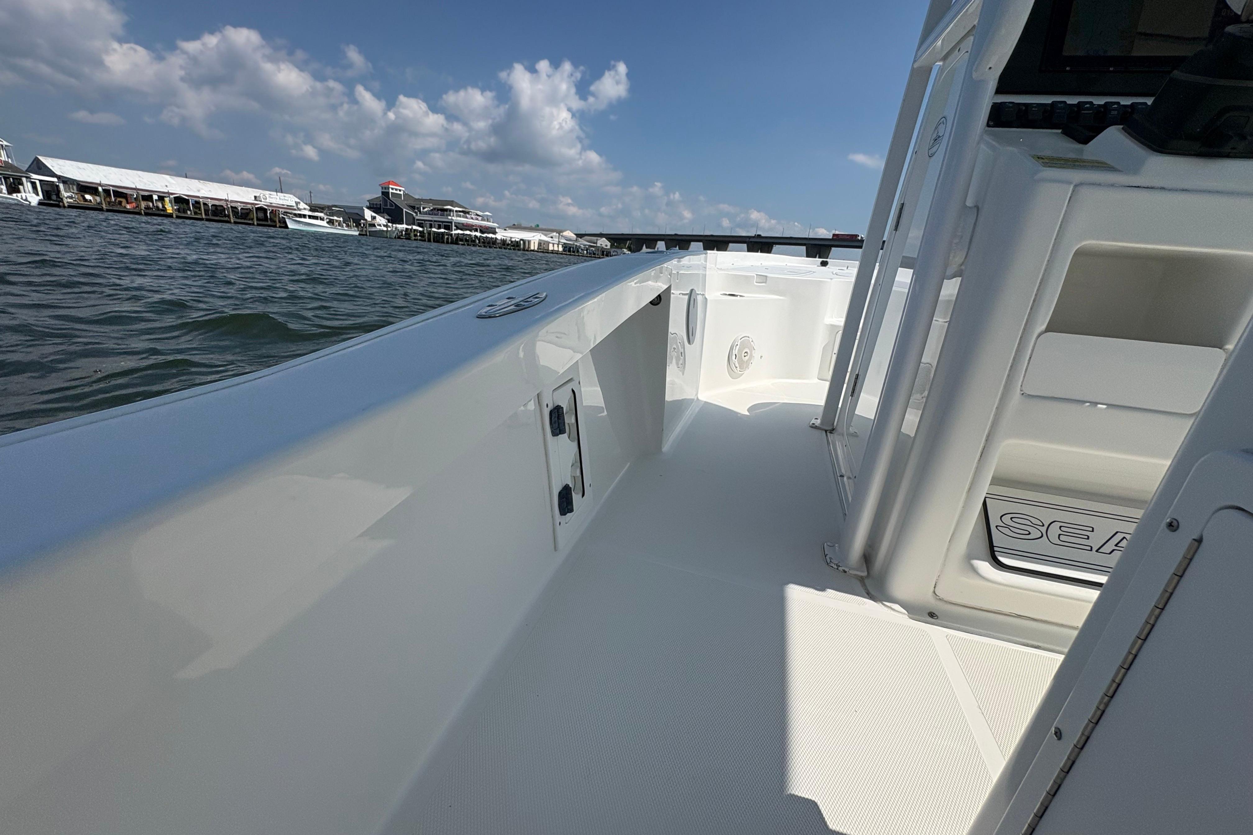 2017 Sea Hunt BX 25 BR boat on water, clear sky, dock in background.