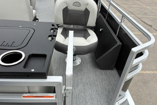 2026 Sun Tracker Fishin' Barge 22 DLX interior with seating and fishing station.