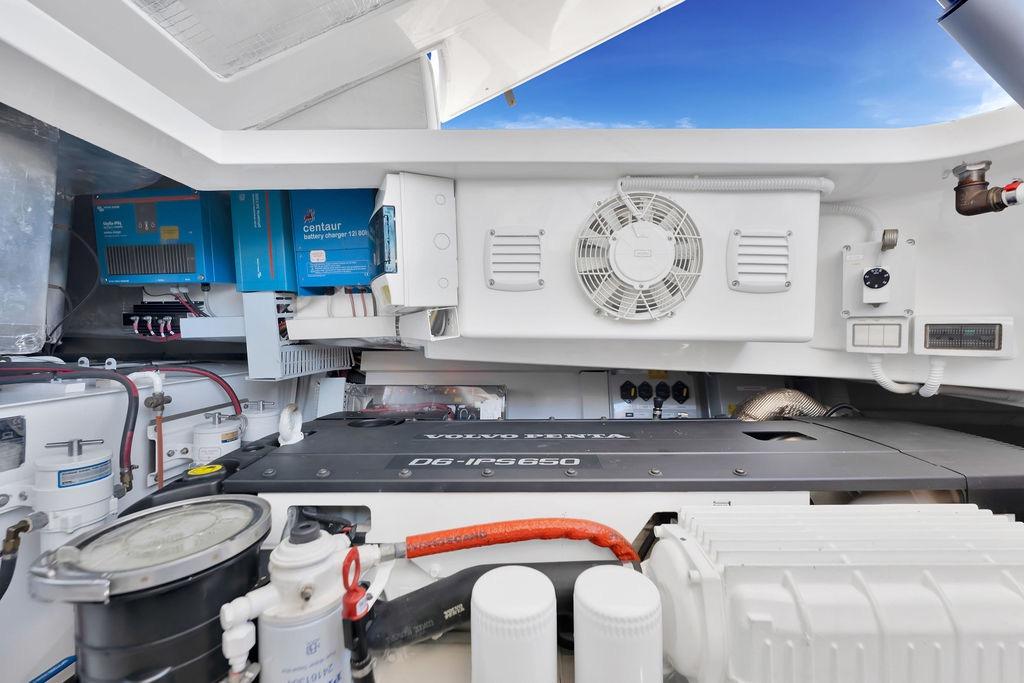 Engine room of 2021 Bluegame BG 42 yacht with Volvo Penta engine and Centaur battery charger.