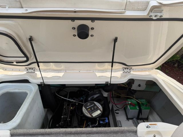 Engine compartment of a 2012 Bayliner 184 SF boat with open hatch.
