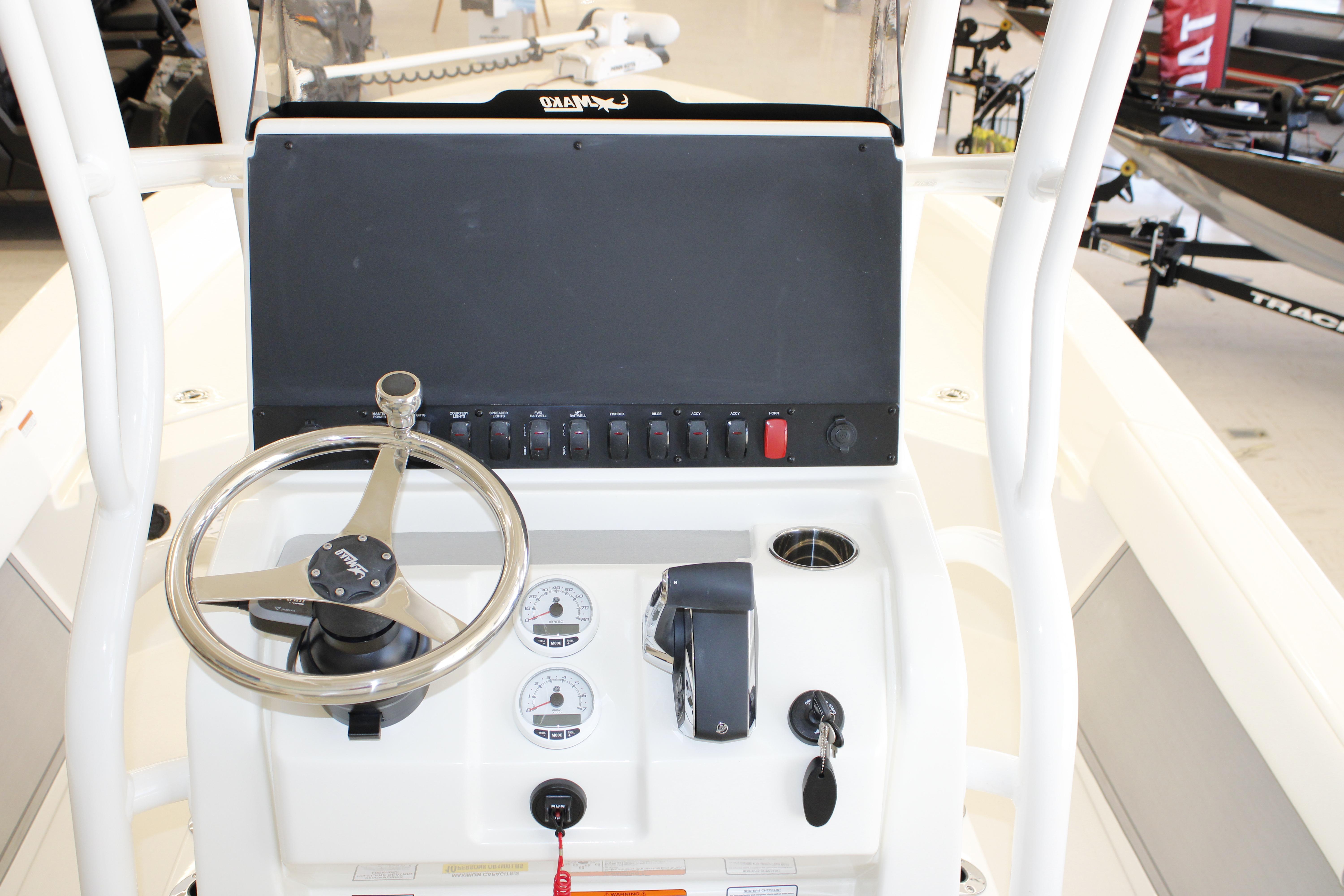 Steering console of 2026 Mako 24 APEX boat with controls and gauges.
