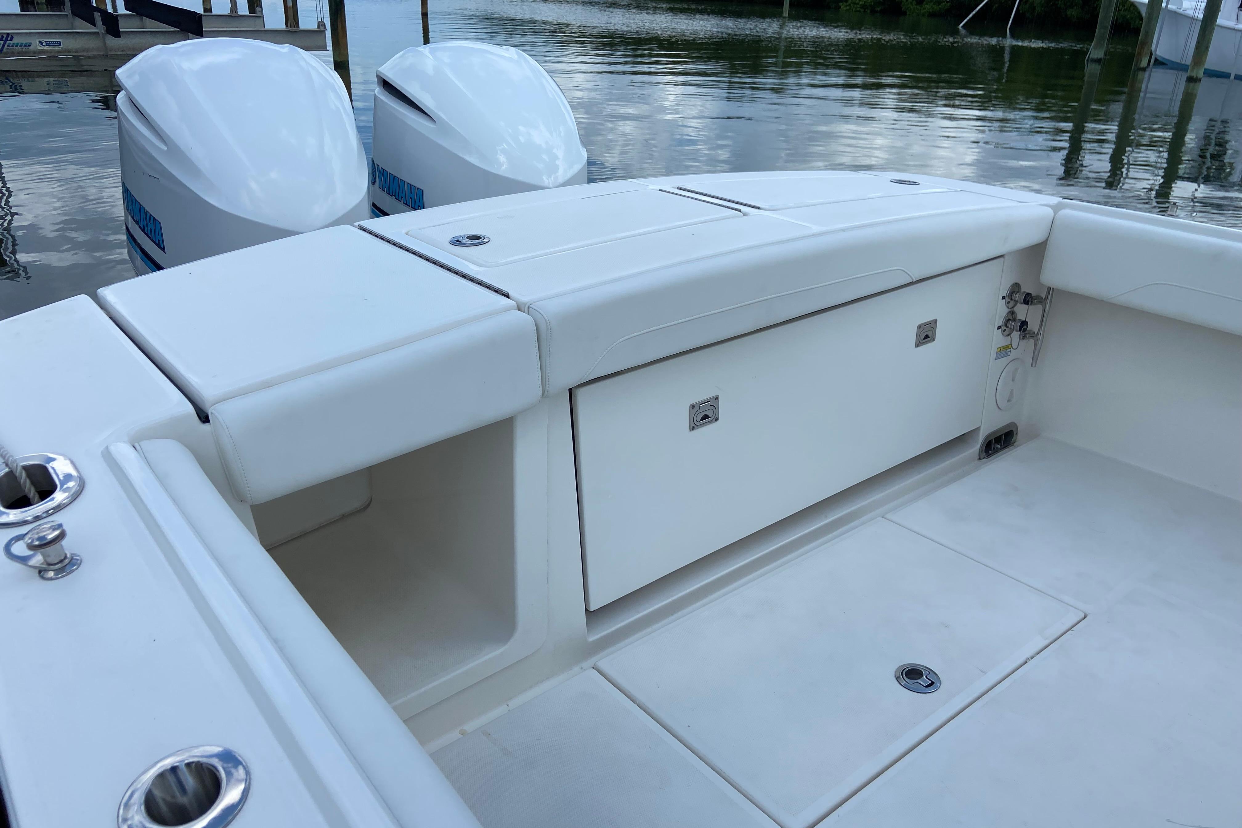 2021 Regulator 28 boat interior with storage compartments and twin outboard engines.