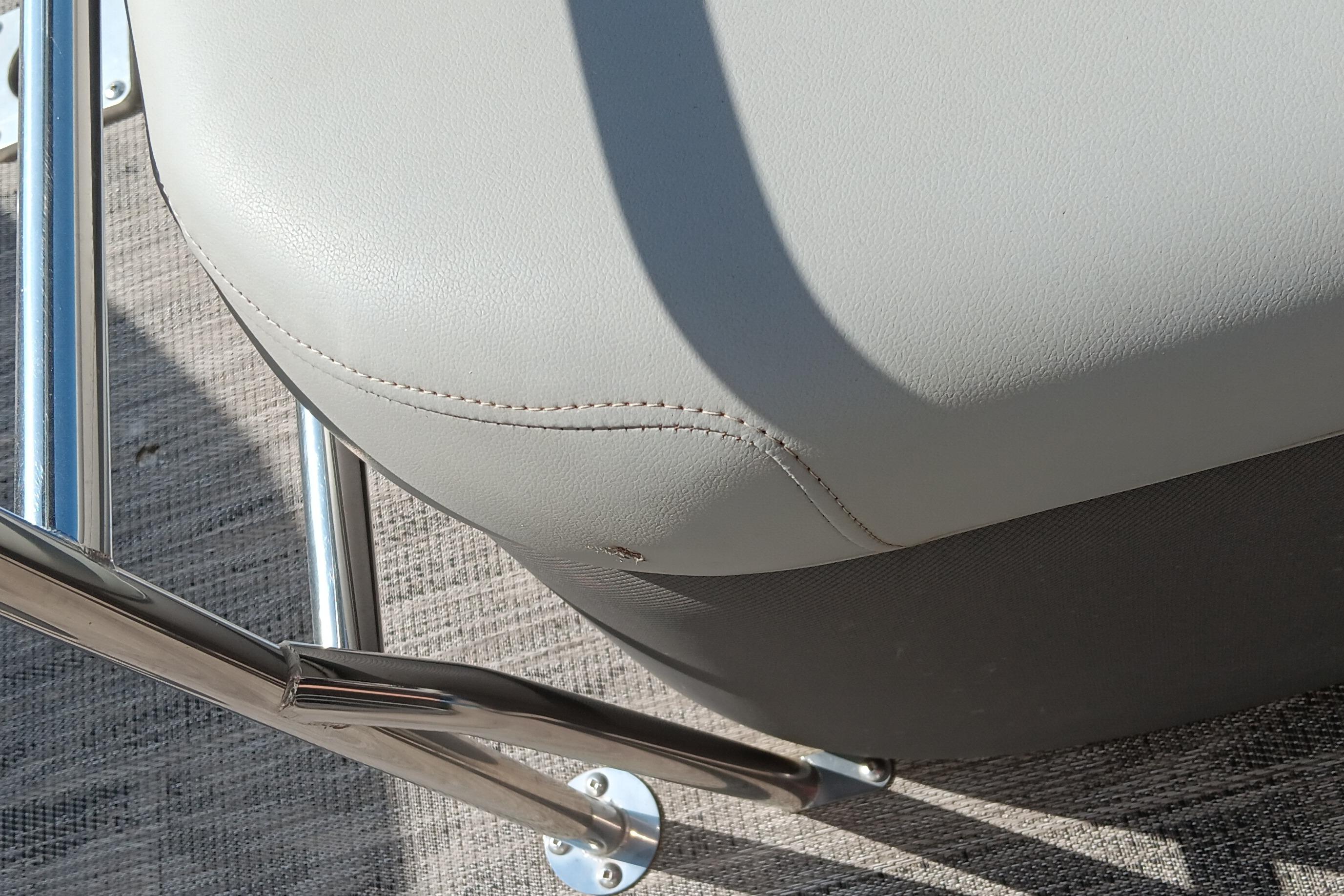 Close-up of a 2023 Ranger 2500LS boat seat with metal railing.
