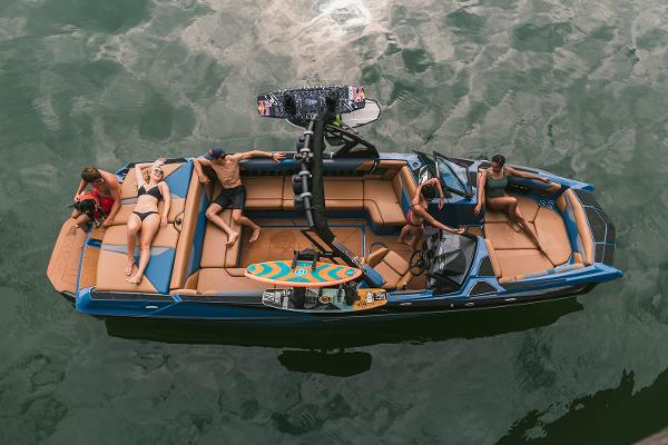 Manufacturer Provided Image: 2021 Axis A24 boat with people relaxing on the water.