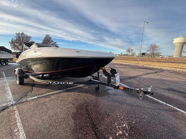 2023 Tahoe T16 boat on trailer in parking lot under cloudy sky.